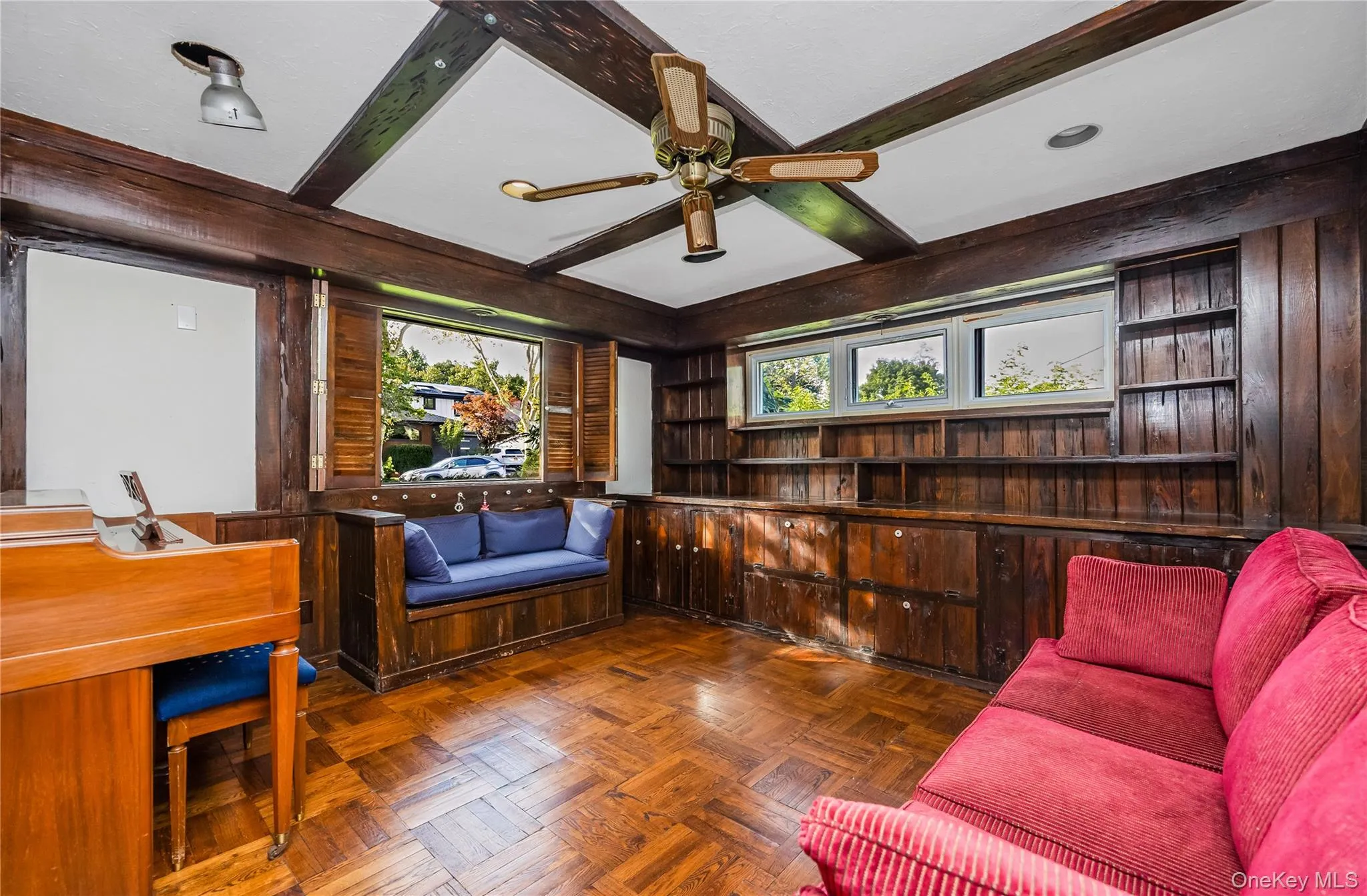 Wood-finish beamed ceiling, wood-finish flooring, wood-finish wall paneling, built-in shelving, and a built-in window seat. Potential 4th bedroom on main floor Wood-finish beamed ceiling, wood-finish flooring, wood-finish wall paneling, built-in shelving, and a built-in window seat. Potential 4th bedroom on main floor