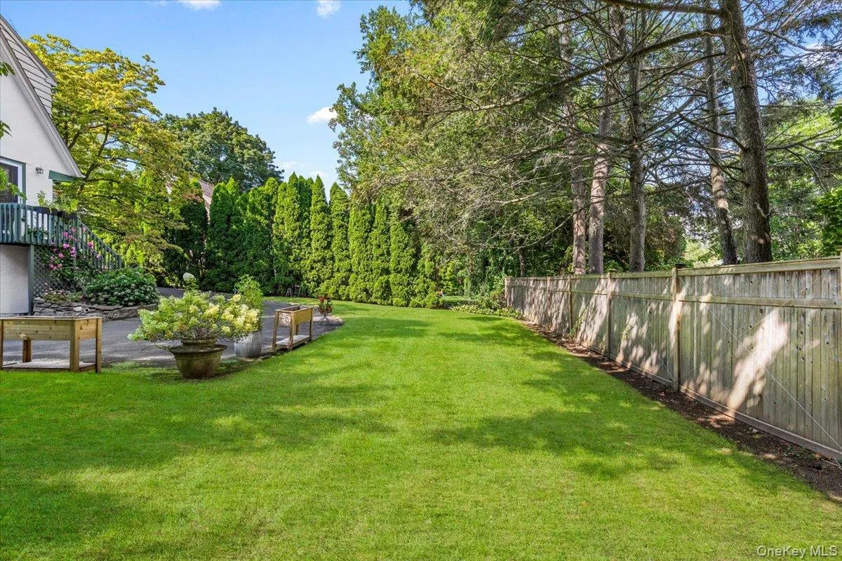 Private, level yard bordered by mature landscaping Private, level yard bordered by mature landscaping