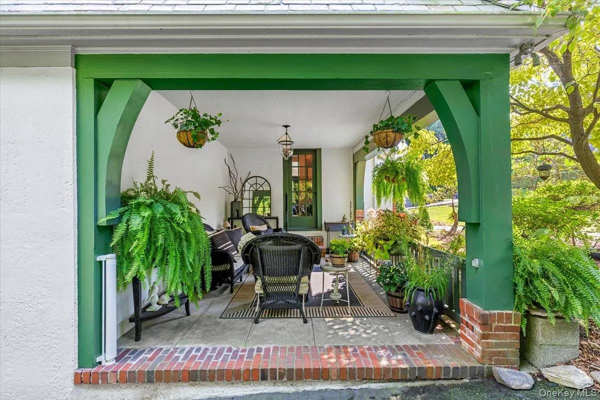 Charming covered porch surrounded by mature landscaping Charming covered porch surrounded by mature landscaping