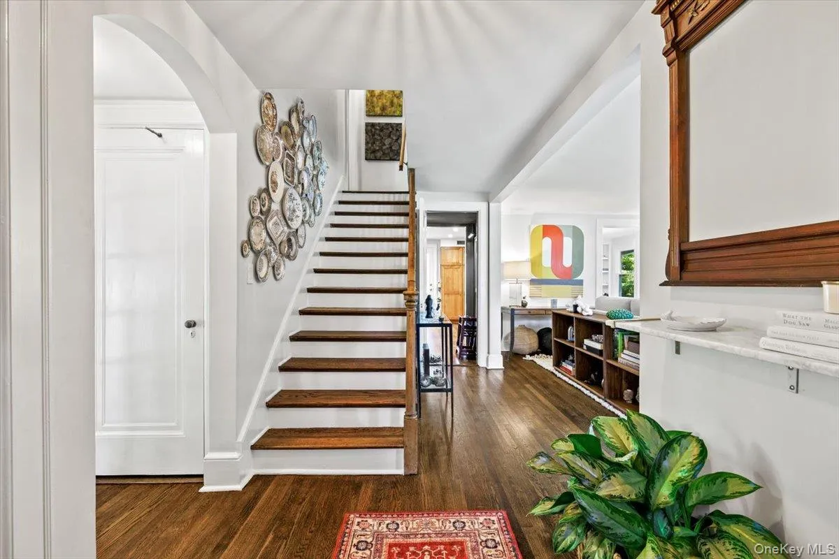 Classic staircase, arched openings, and refinished hardwood floors Classic staircase, arched openings, and refinished hardwood floors