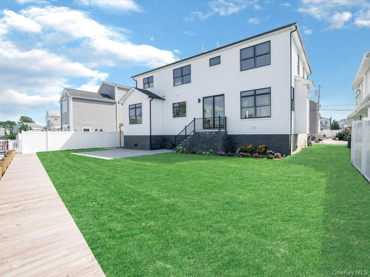 White siding exterior with dark trim windows White siding exterior with dark trim windows