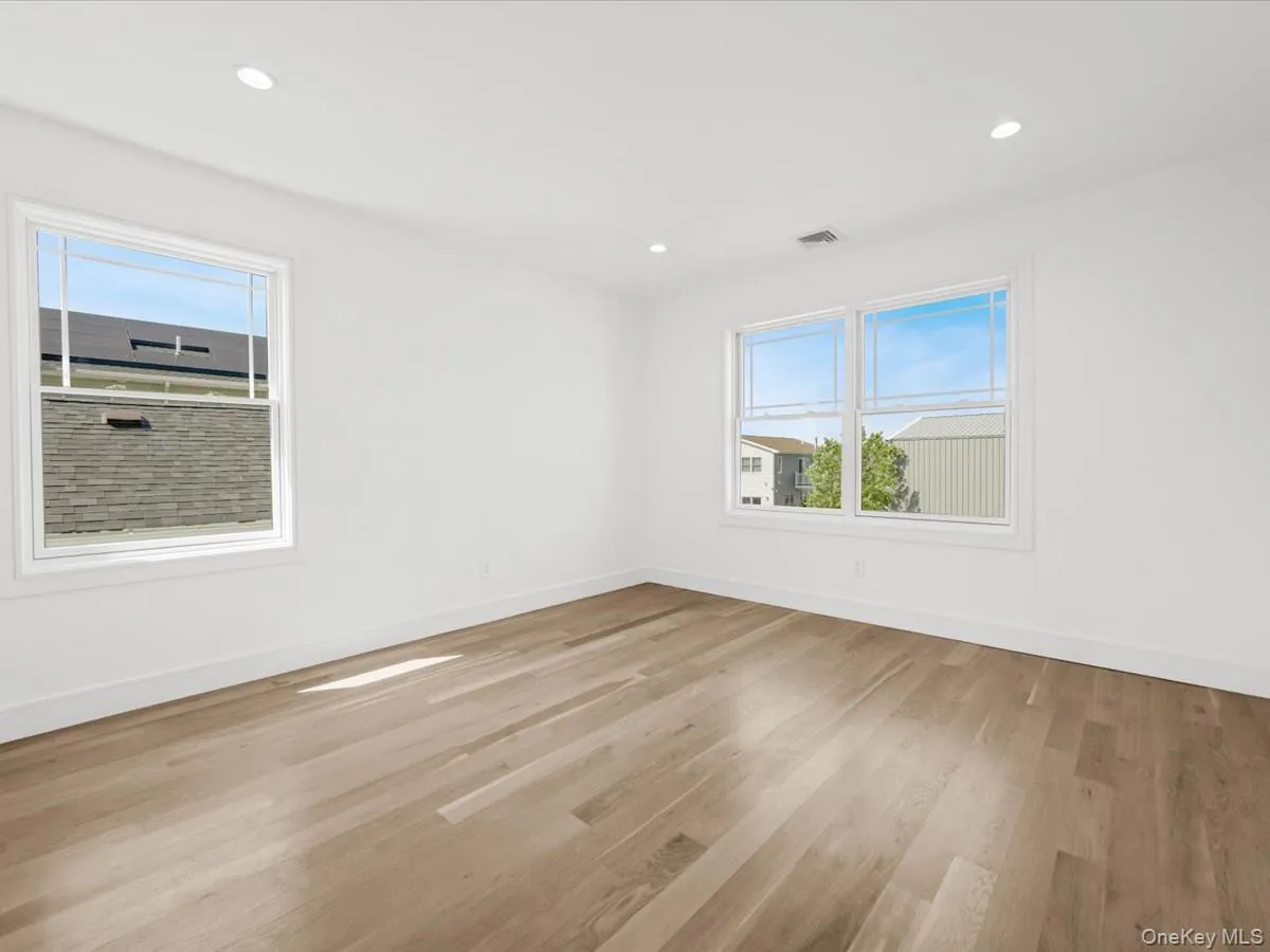 Recessed lighting, wood-finish flooring, and multiple windows Recessed lighting, wood-finish flooring, and multiple windows