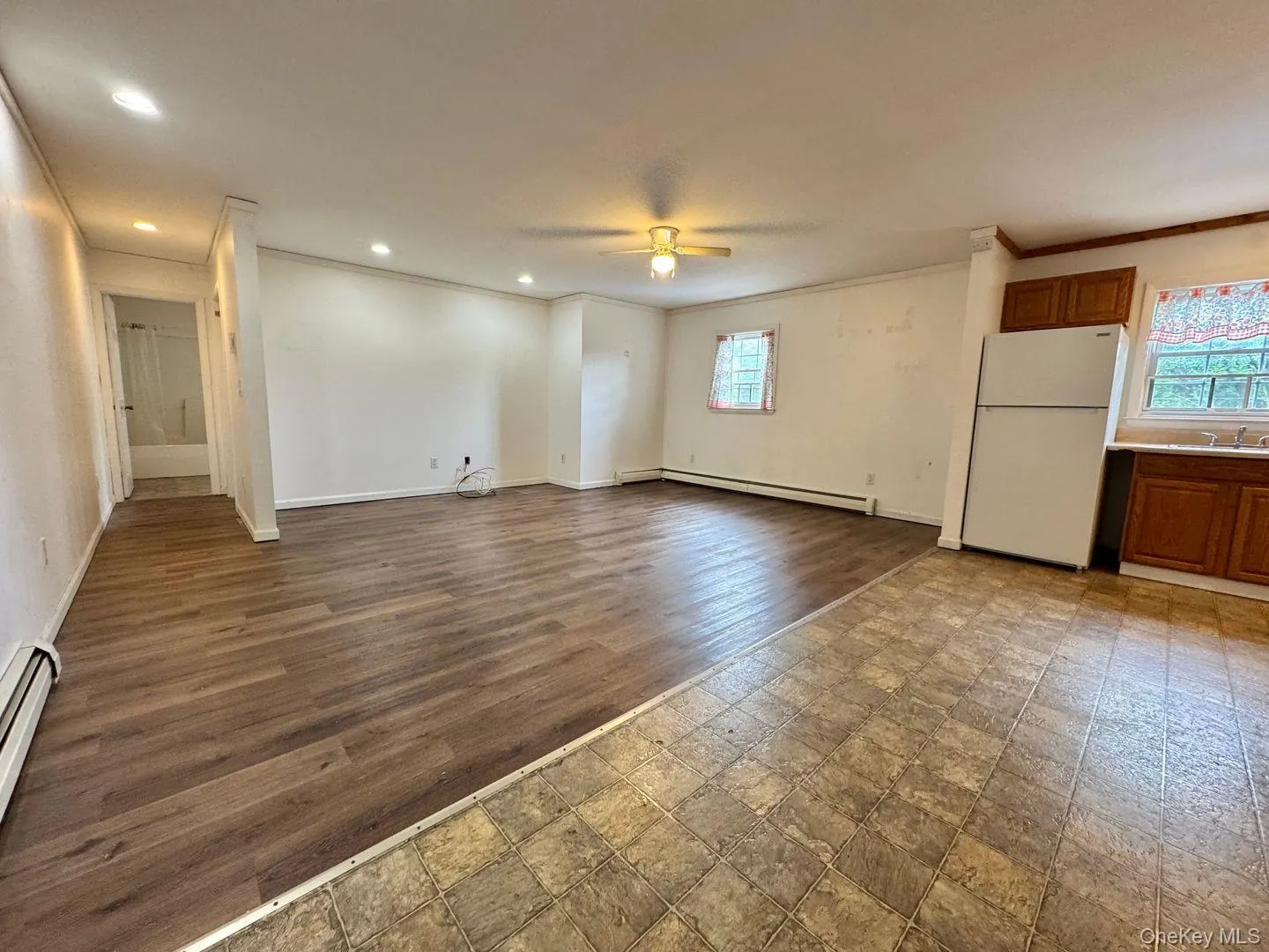 Living room, kitchen from entrance. Living room, kitchen from entrance.