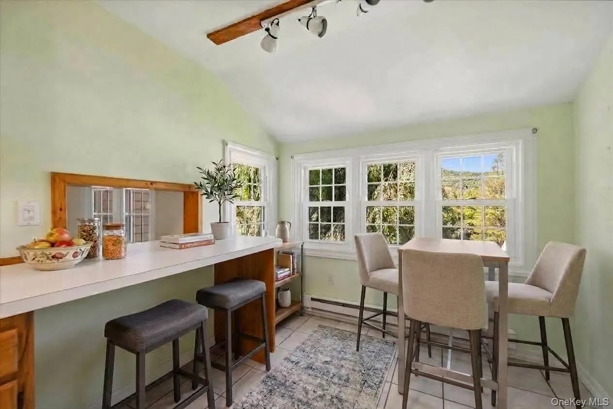 Seating at the breakfast bar and table for 4-virtually staged Seating at the breakfast bar and table for 4-virtually staged