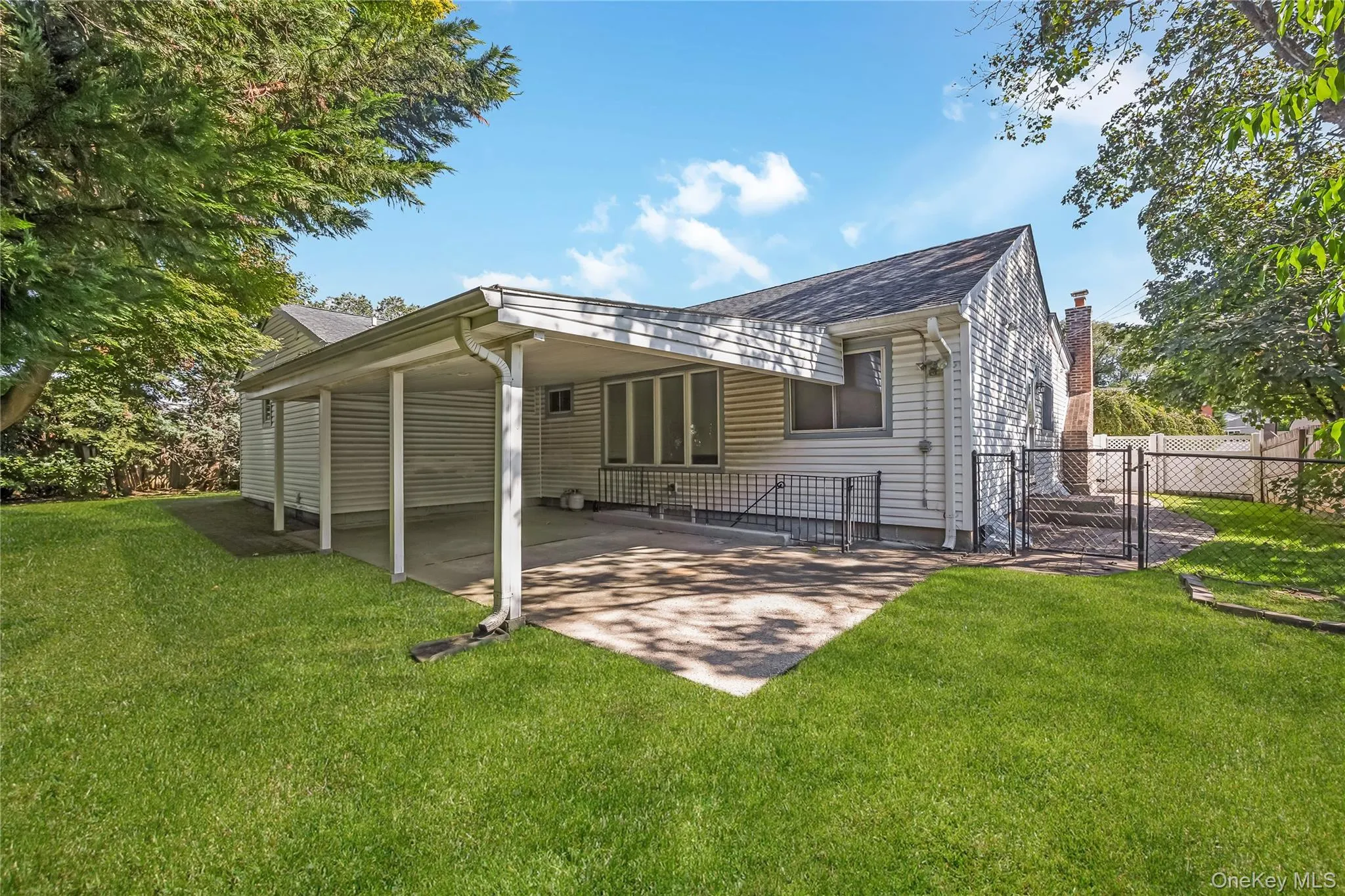 Beautiful yard with mature trees and covered patio. Grass virtually enhanced Beautiful yard with mature trees and covered patio. Grass virtually enhanced
