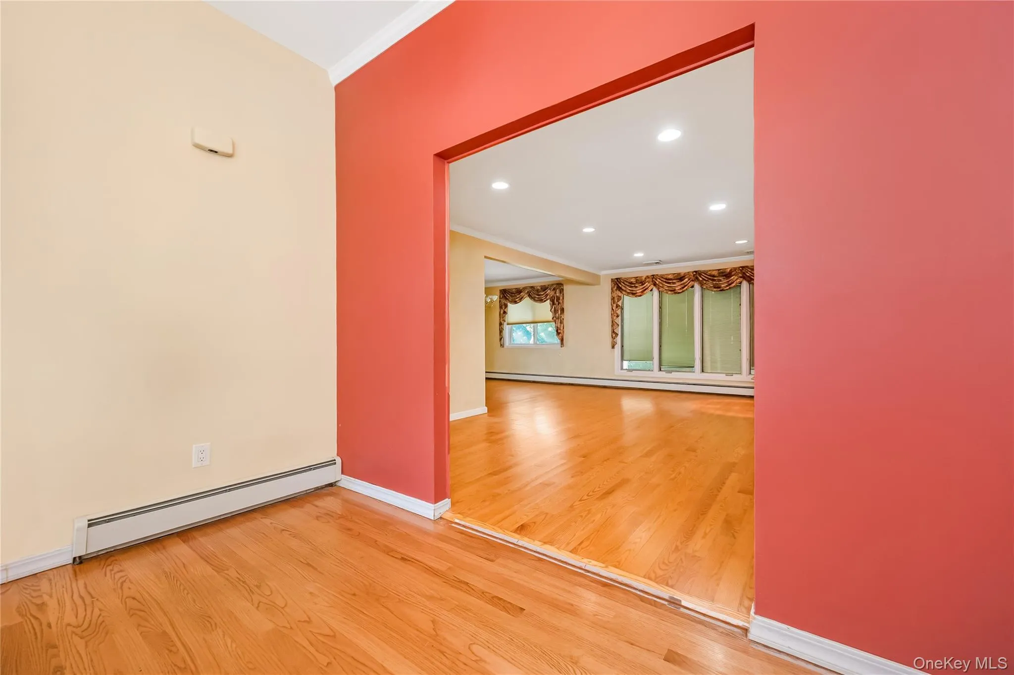 Foyer leading into the large Living room/dining room with hardwood flooring throughout, recessed lighting, and multiple large windows Foyer leading into the large Living room/dining room with hardwood flooring throughout, recessed lighting, and multiple large windows