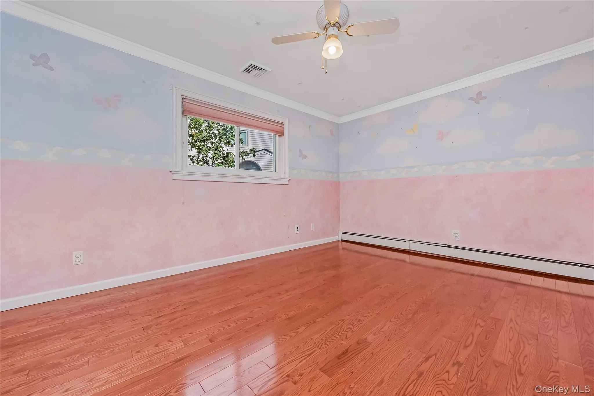 Bedroom 2 with hardwood flooring, crown molding, window with blinds, ceiling fan with light fixture and a double closet Bedroom 2 with hardwood flooring, crown molding, window with blinds, ceiling fan with light fixture and a double closet