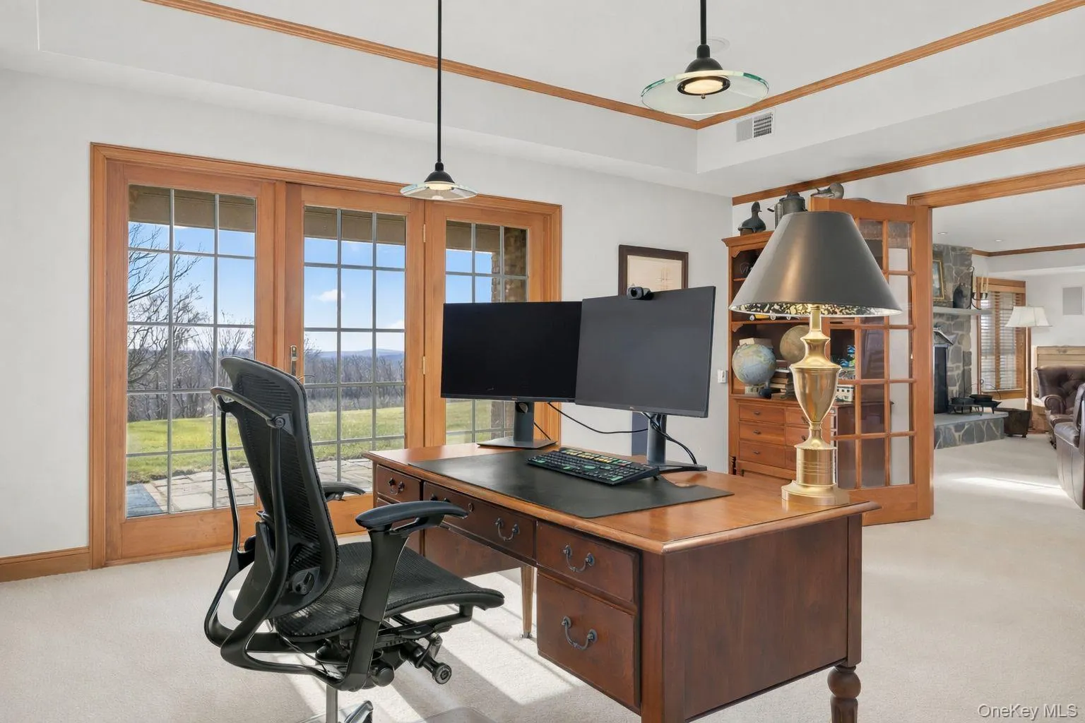 Lower level office with built-ins, storage, and doors to covered patio Lower level office with built-ins, storage, and doors to covered patio