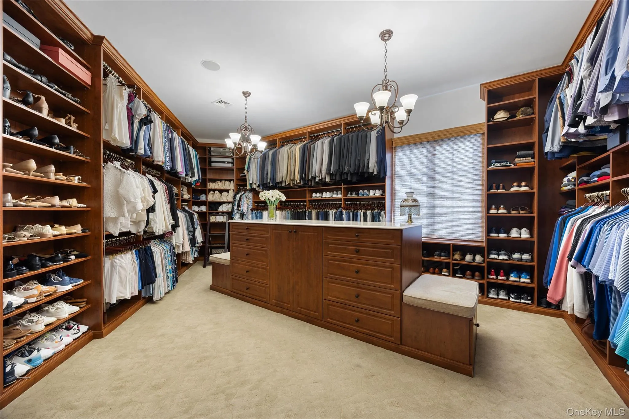 Primary his/hers walk-in closet. Primary his/hers walk-in closet.
