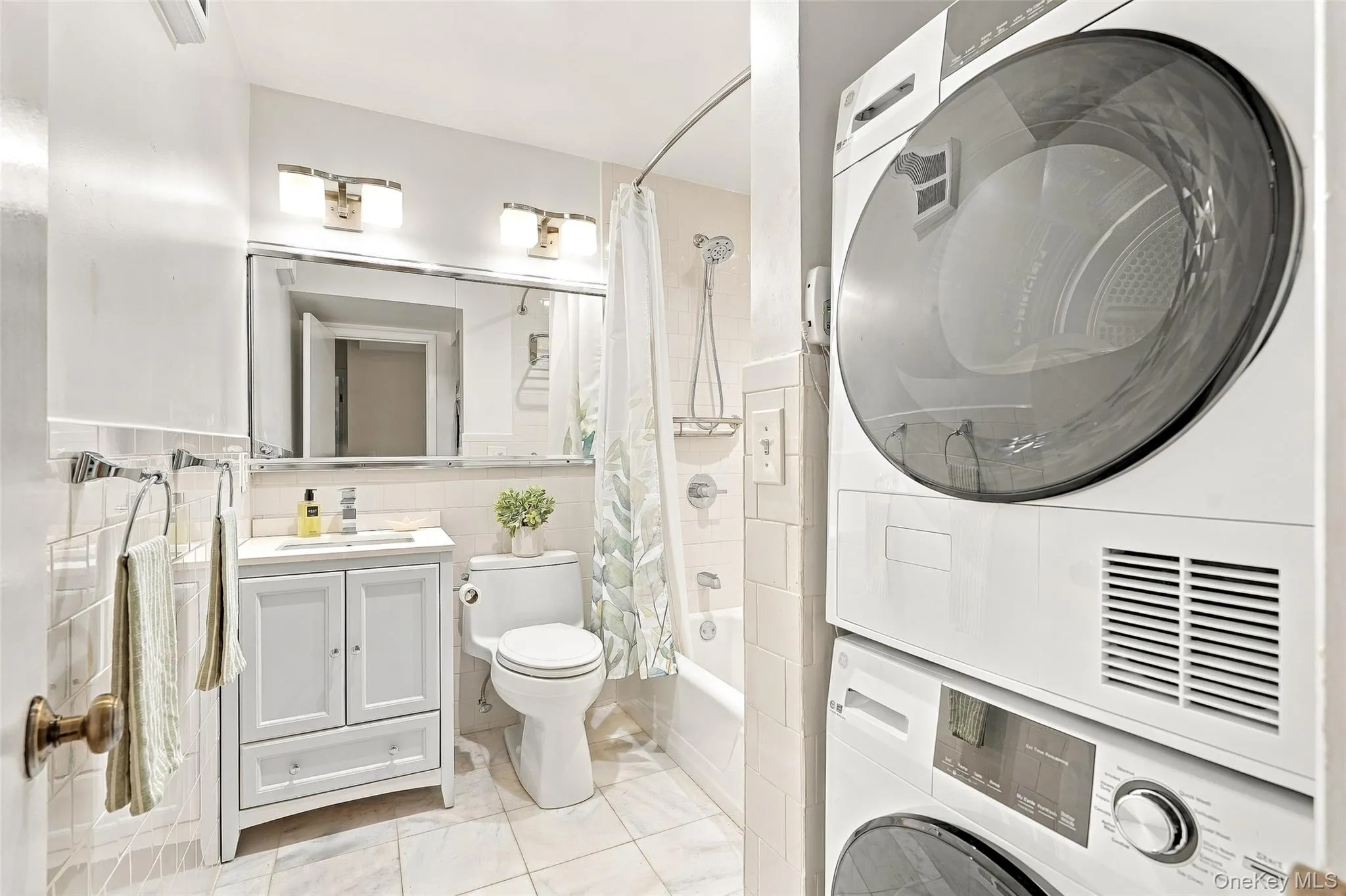 Brand new top of the line stackable GE washer and dryer fits conveniently into the full hall bath Brand new top of the line stackable GE washer and dryer fits conveniently into the full hall bath