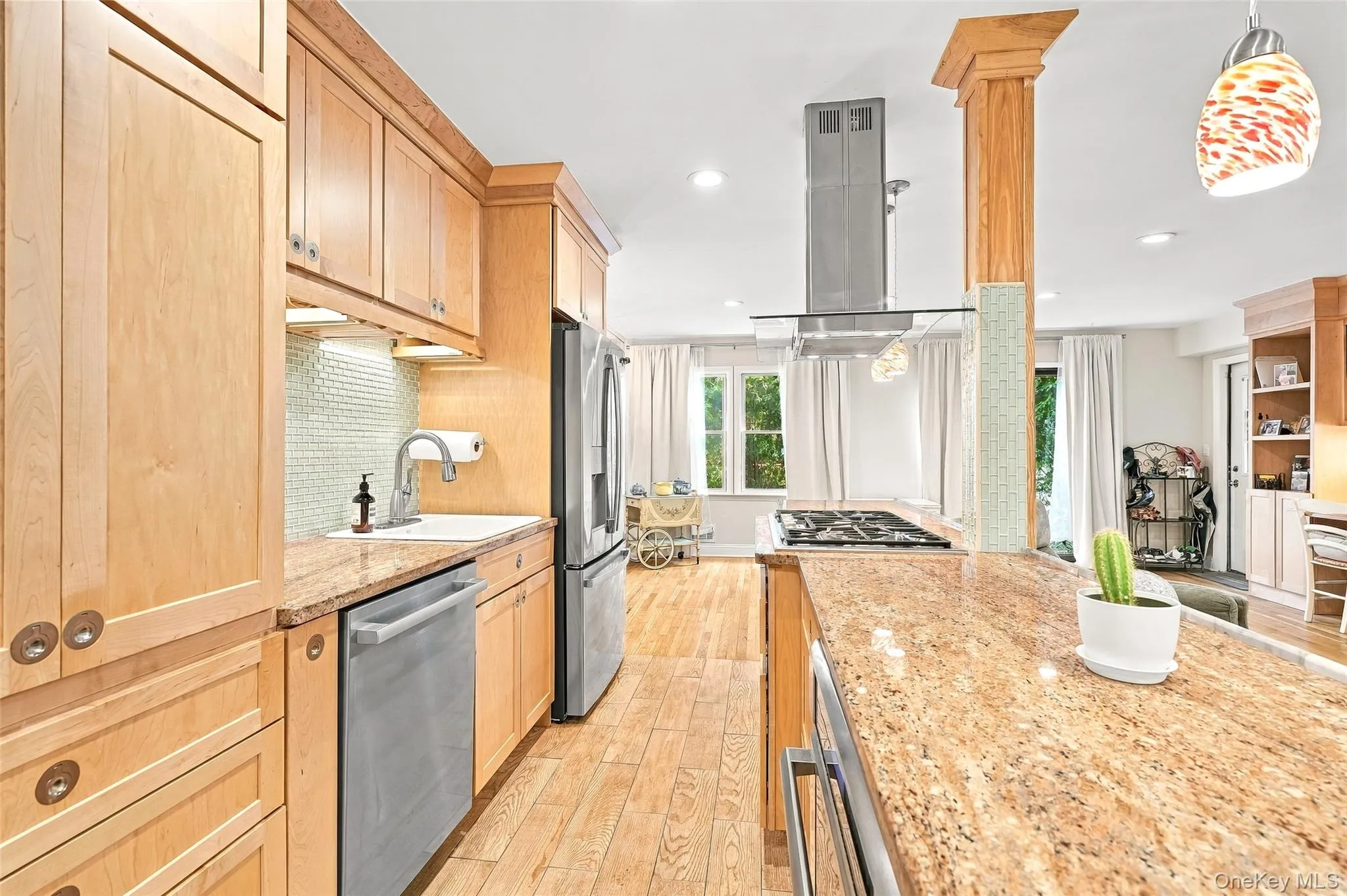 Long granite expanse is perfect for food prepping as you greet guests and family Long granite expanse is perfect for food prepping as you greet guests and family