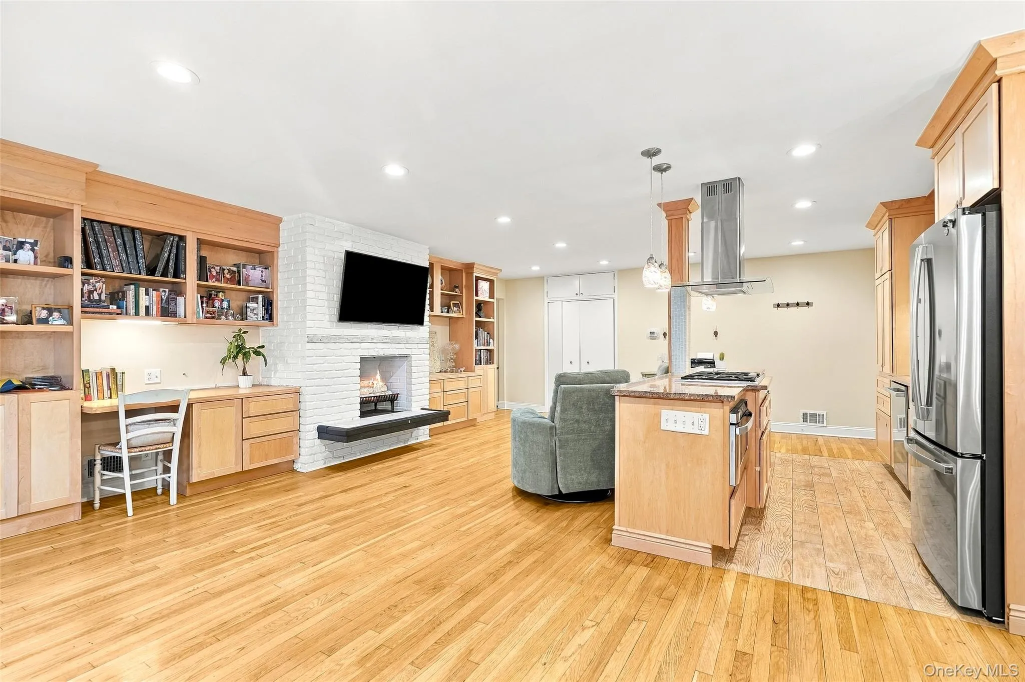 The open kitchen blends seamlessly into the living space including a cozy wood burning fireplace. The open kitchen blends seamlessly into the living space including a cozy wood burning fireplace.