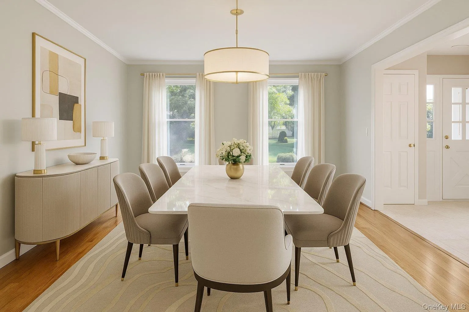 Dining space featuring light wood-type flooring and crown molding Dining space featuring light wood-type flooring and crown molding
