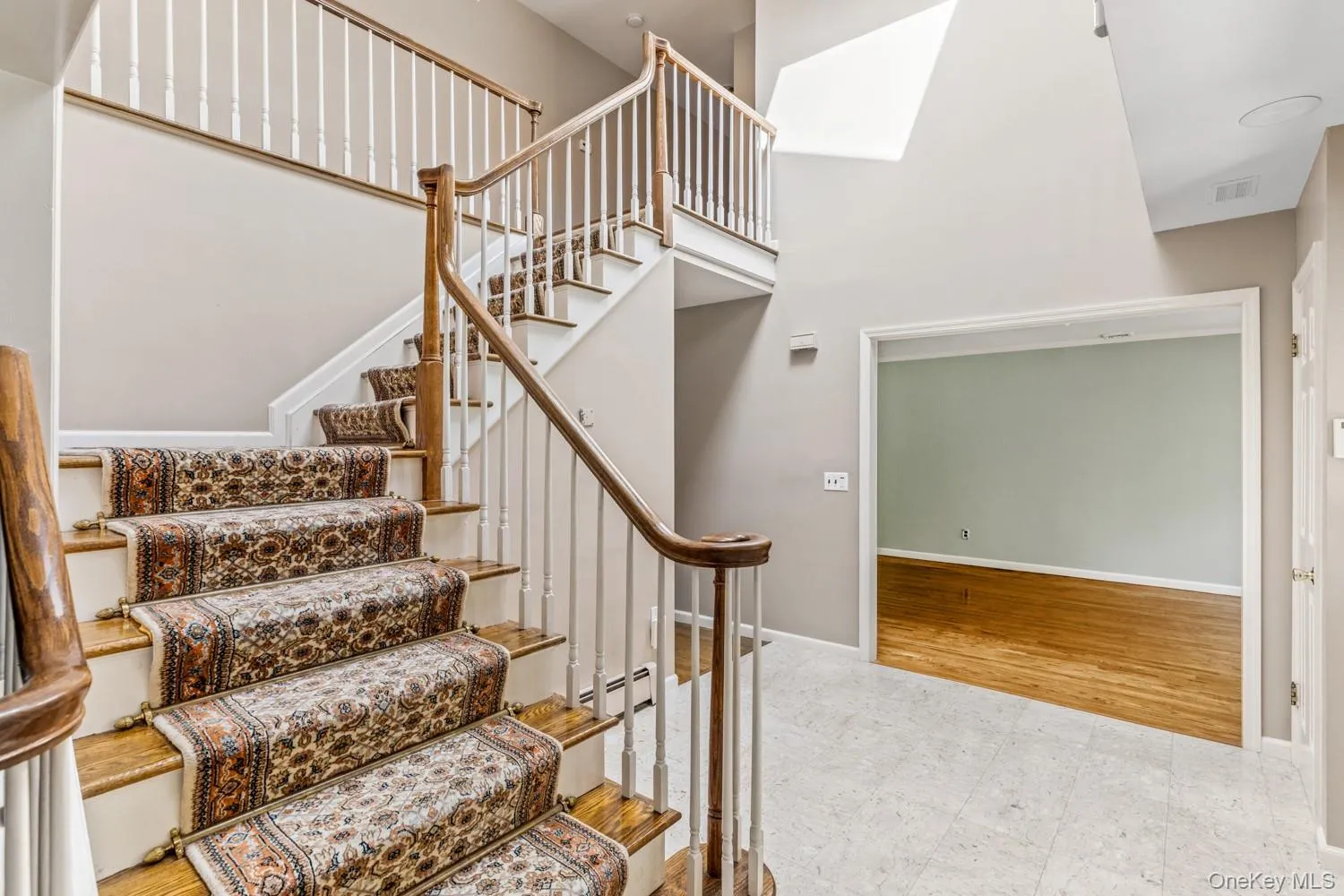 Stairway with a high ceiling and baseboard heating Stairway with a high ceiling and baseboard heating