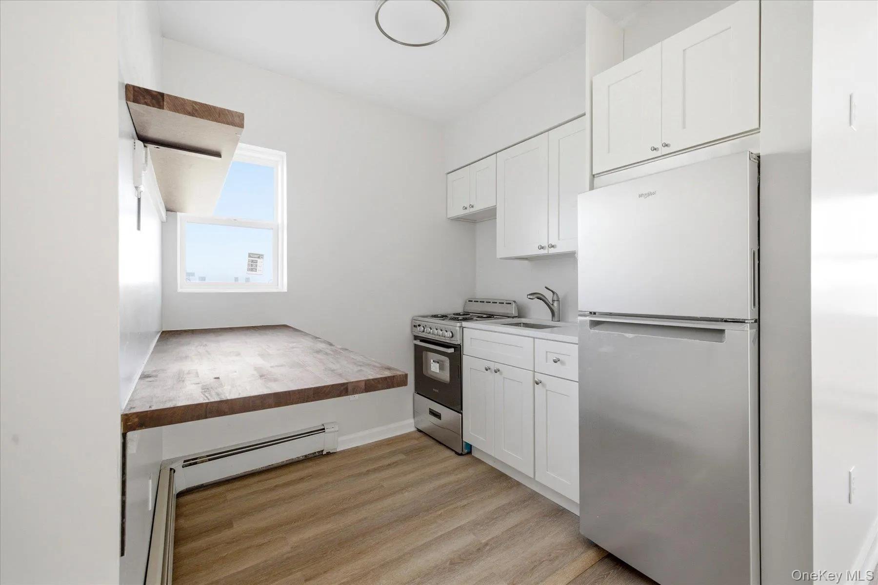 Kitchen with a breakfast nook and brand new stainless steel appliances + gas cooking Kitchen with a breakfast nook and brand new stainless steel appliances + gas cooking