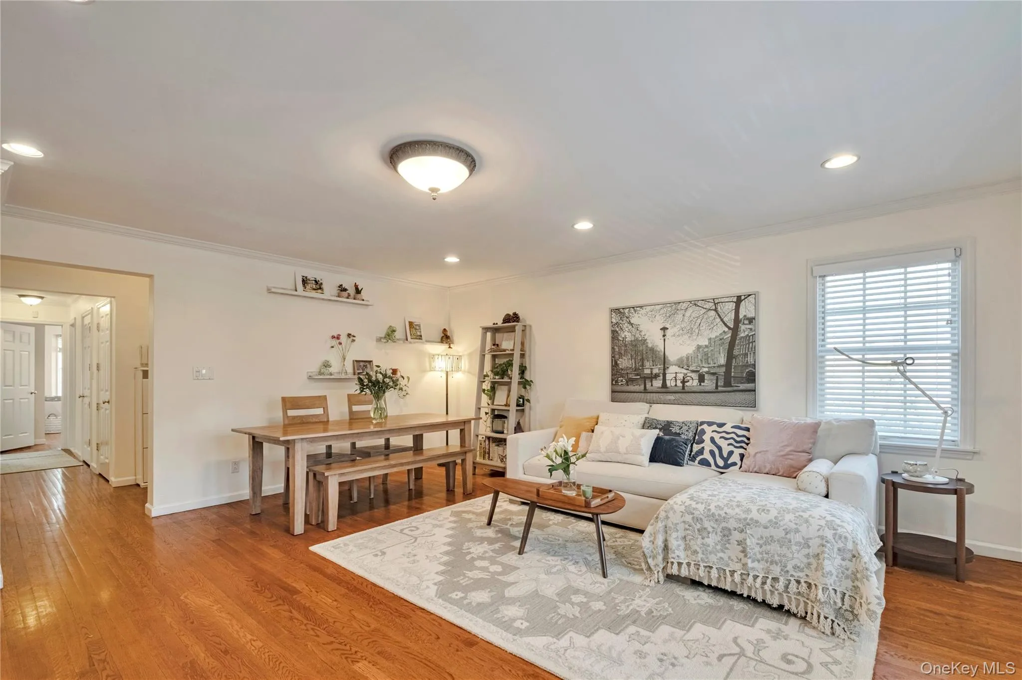 Living area with ornamental molding, wood finished floors, and recessed lighting Living area with ornamental molding, wood finished floors, and recessed lighting