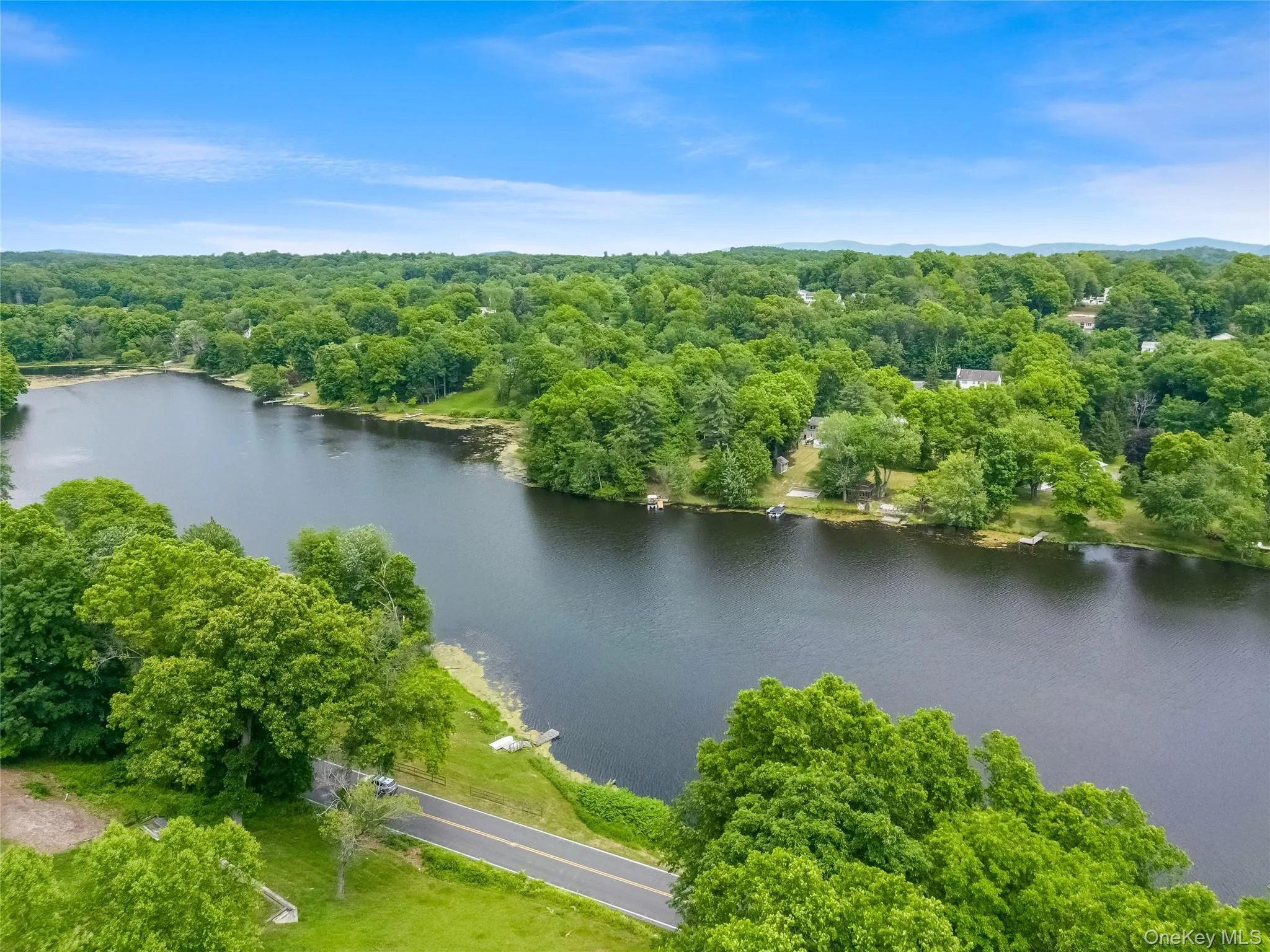 Expansive lakefront setting surrounded by mature trees Expansive lakefront setting surrounded by mature trees
