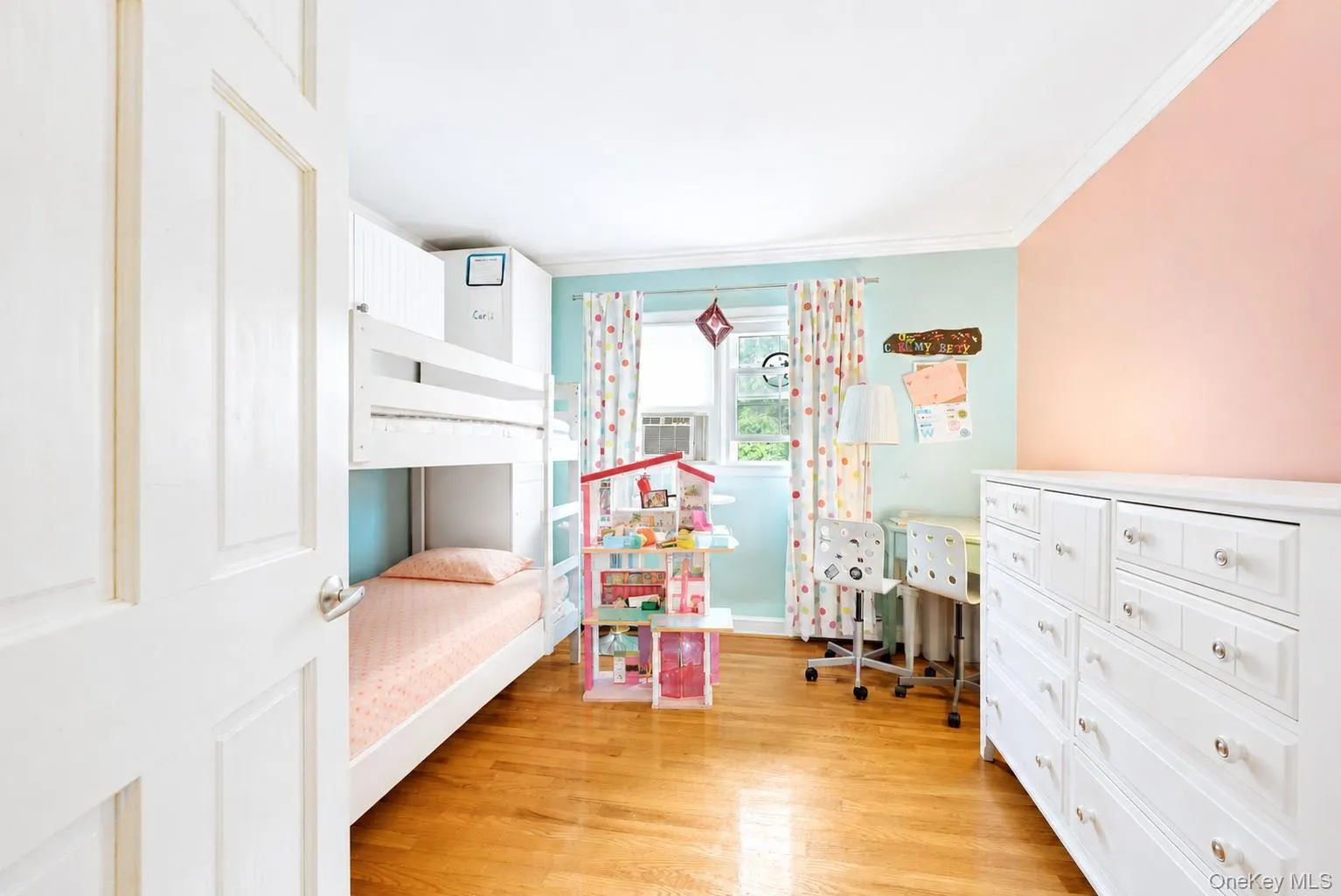 Bright room featuring hardwood flooring, white crown molding, a window with natural light, and a built-in bunk bed structure Bright room featuring hardwood flooring, white crown molding, a window with natural light, and a built-in bunk bed structure