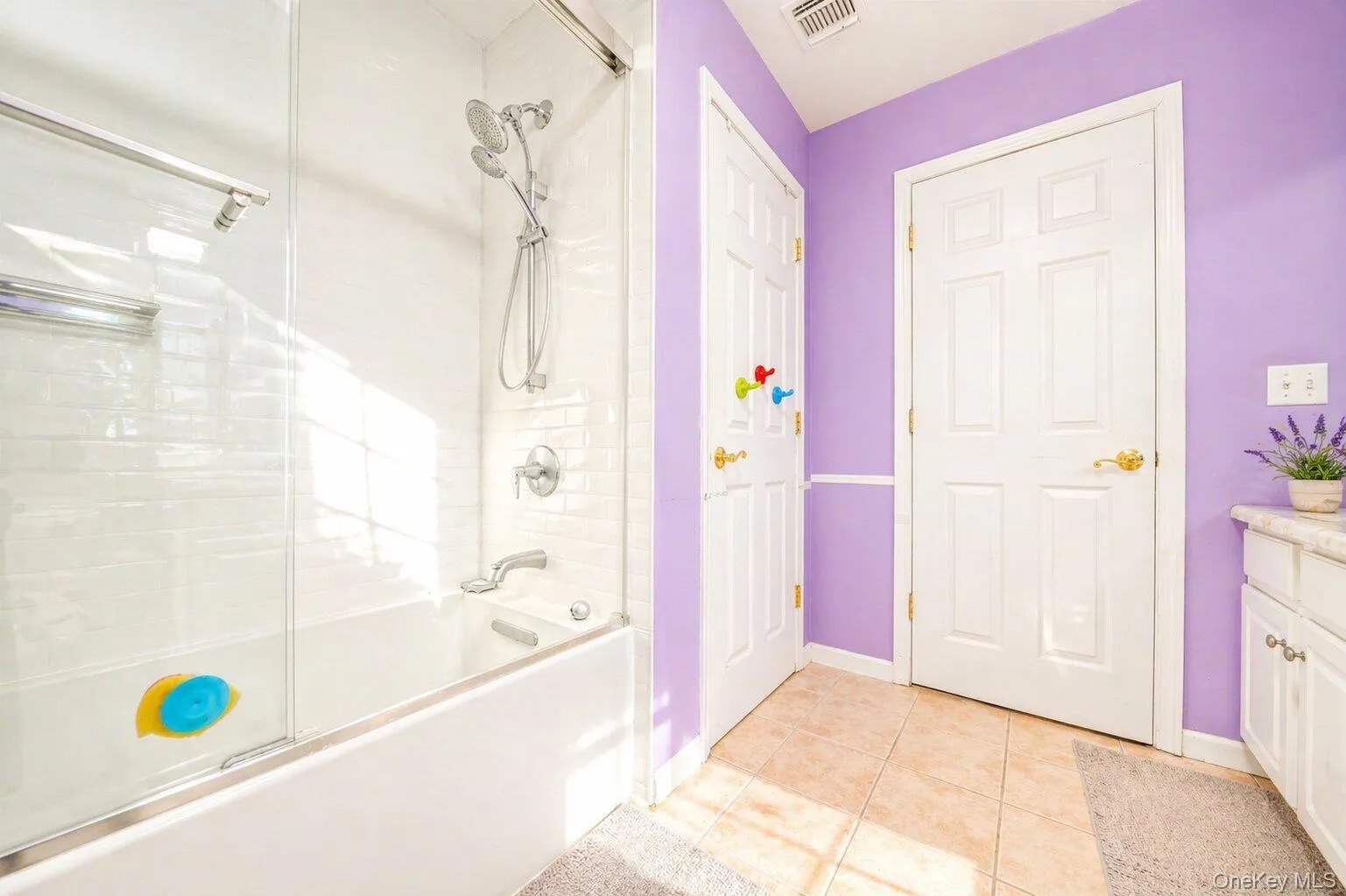 Shower-tub combination with glass enclosure and subway tile surround Shower-tub combination with glass enclosure and subway tile surround