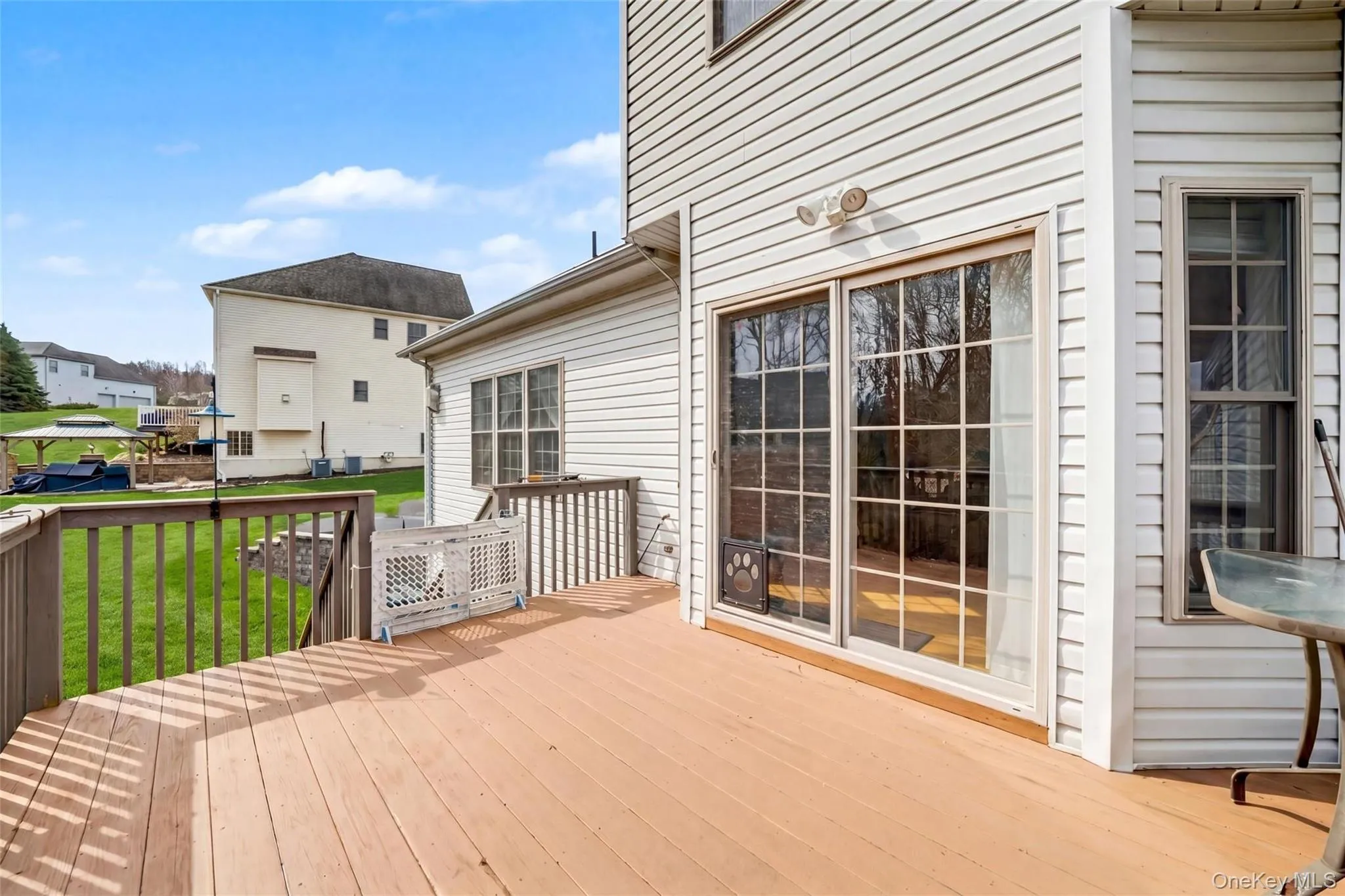 Spacious outdoor deck with wood-finish flooring and full railing Spacious outdoor deck with wood-finish flooring and full railing
