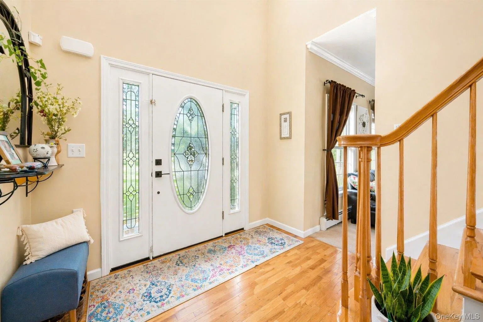 Entryway featuring a white door with oval leaded glass, flanked by two sidelights with matching leaded glass Entryway featuring a white door with oval leaded glass, flanked by two sidelights with matching leaded glass