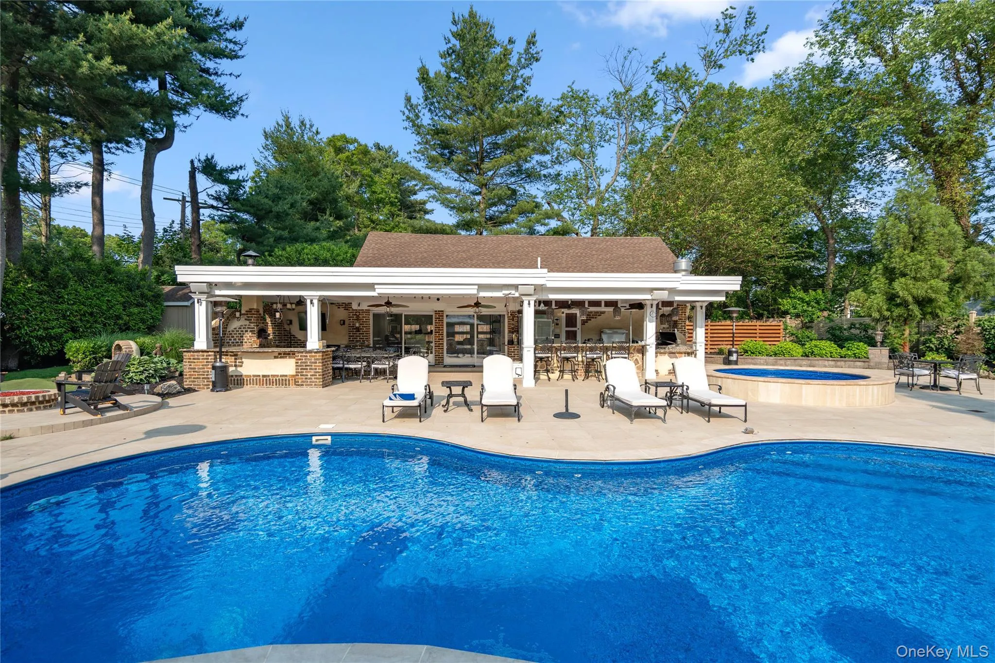 Sparkling pool with 1100 sq -ft pool house and outdoor kitchen with pizza oven Sparkling pool with 1100 sq -ft pool house and outdoor kitchen with pizza oven