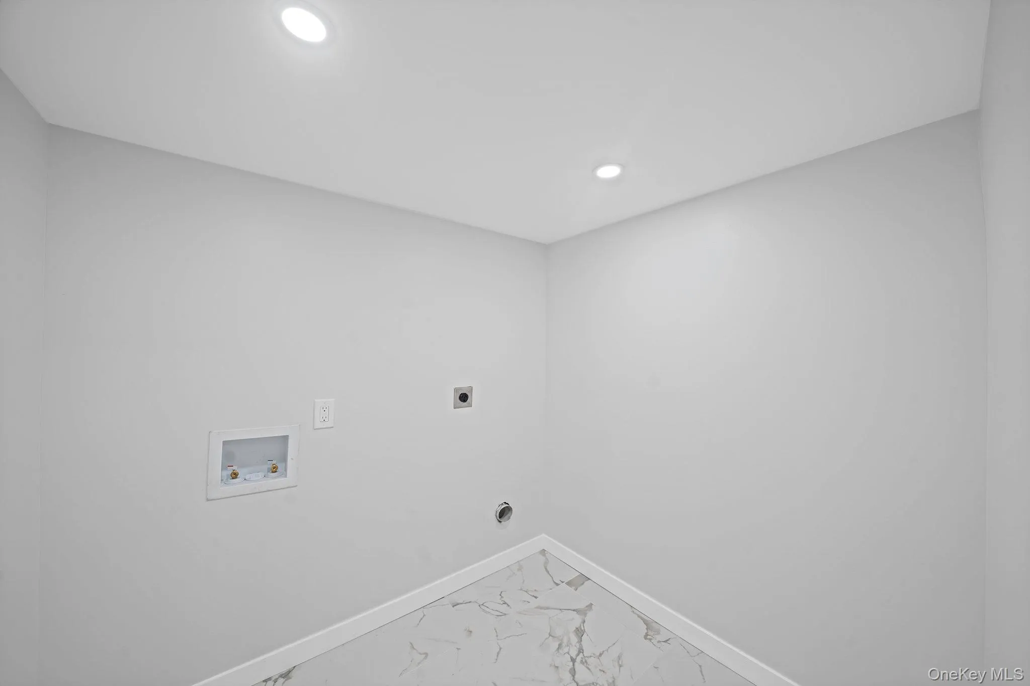 Auxiliary room with laundry hookups in basement. Auxiliary room with laundry hookups in basement.