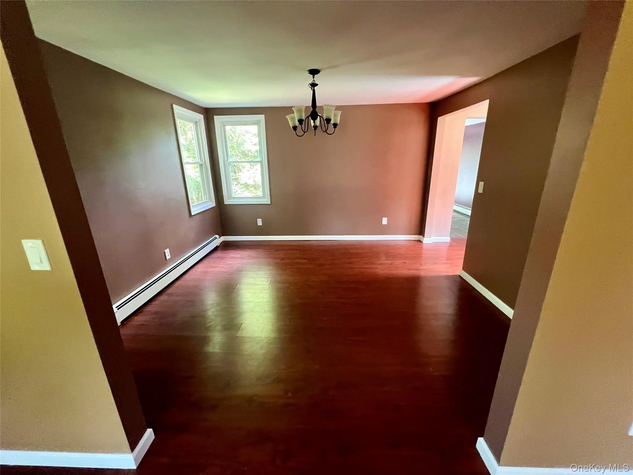 Separate dining area with hardwood-style flooring and chandelier. Separate dining area with hardwood-style flooring and chandelier.