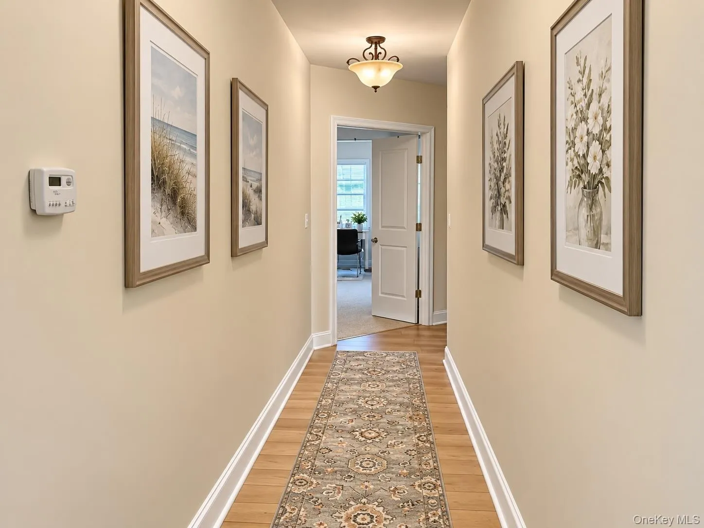 Hallway connecting the living space to the bedrooms and guest bath Hallway connecting the living space to the bedrooms and guest bath