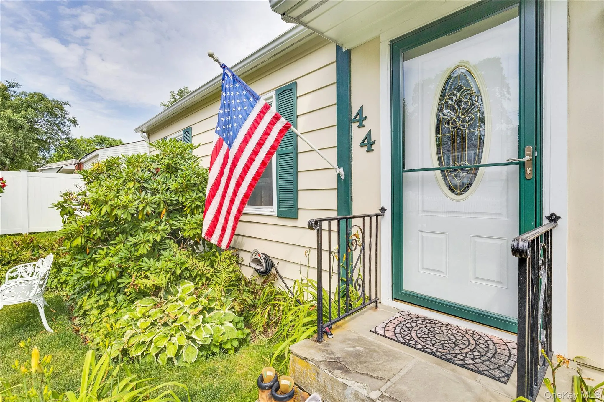 Entryway featuring a decorative storm door, wrought iron railings, and stone steps Entryway featuring a decorative storm door, wrought iron railings, and stone steps