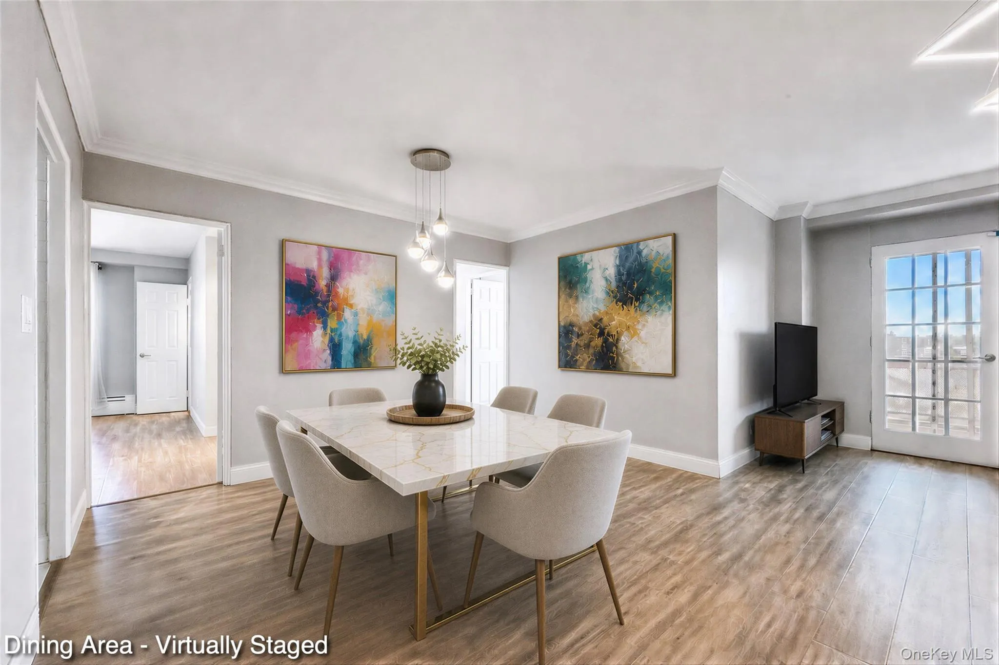 Wood-finish flooring throughout, crown molding, modern chandelier, and French-style glass paneled door Wood-finish flooring throughout, crown molding, modern chandelier, and French-style glass paneled door
