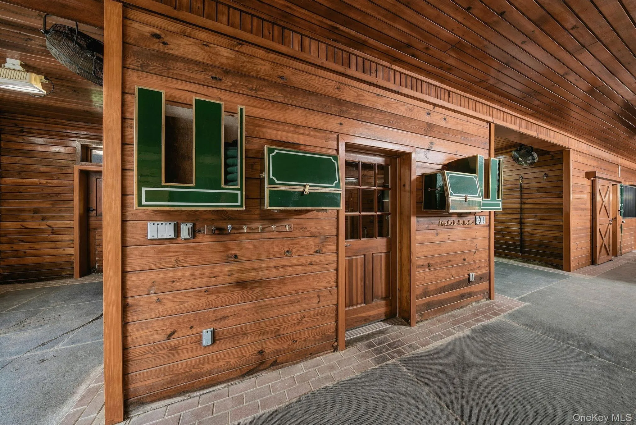 A view of the two wash/grooming stalls and door to the climate-controlled tack room. A view of the two wash/grooming stalls and door to the climate-controlled tack room.