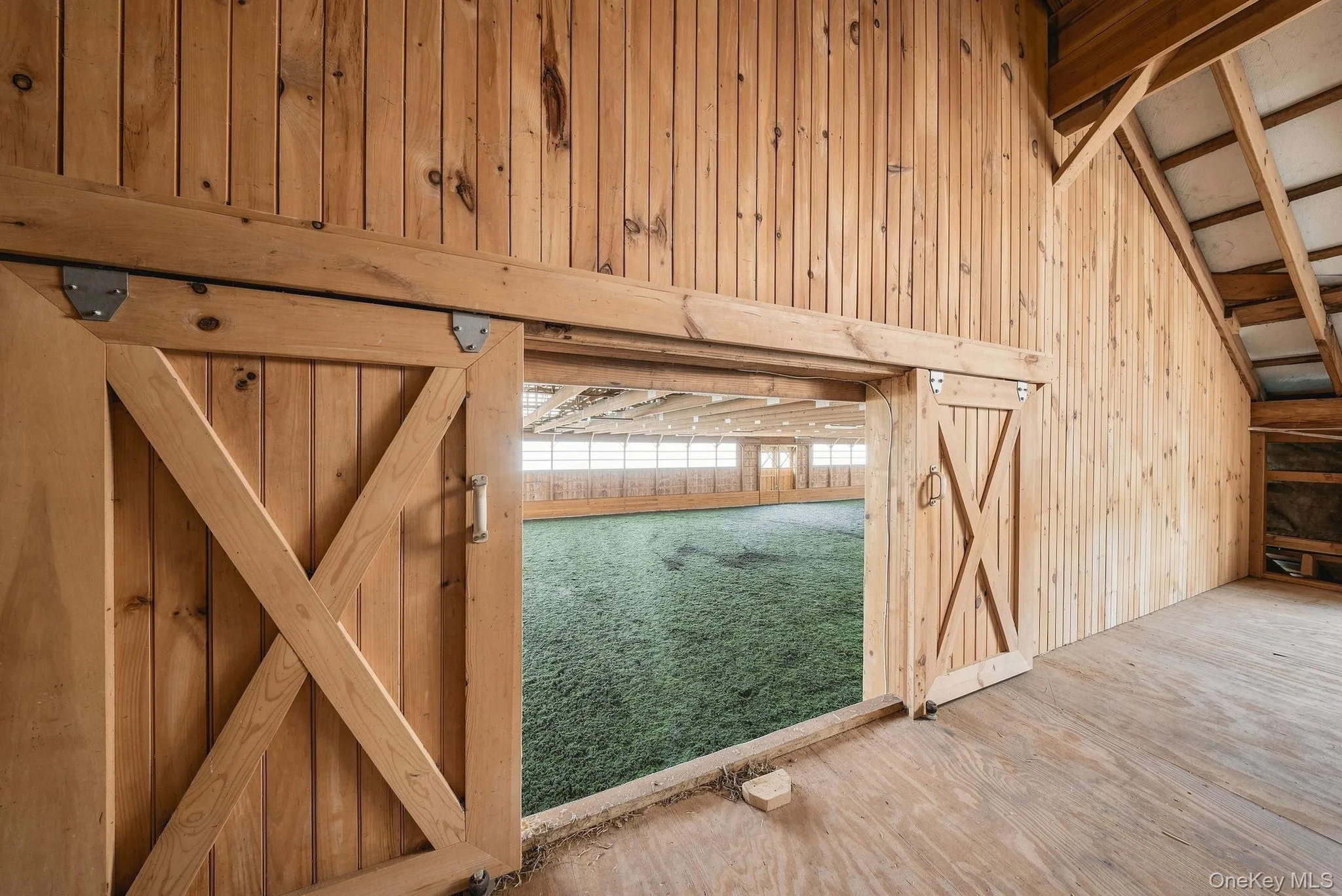 Hayloft doors open to the indoor arena to accommodate future plans for a viewing room. Hayloft doors open to the indoor arena to accommodate future plans for a viewing room.