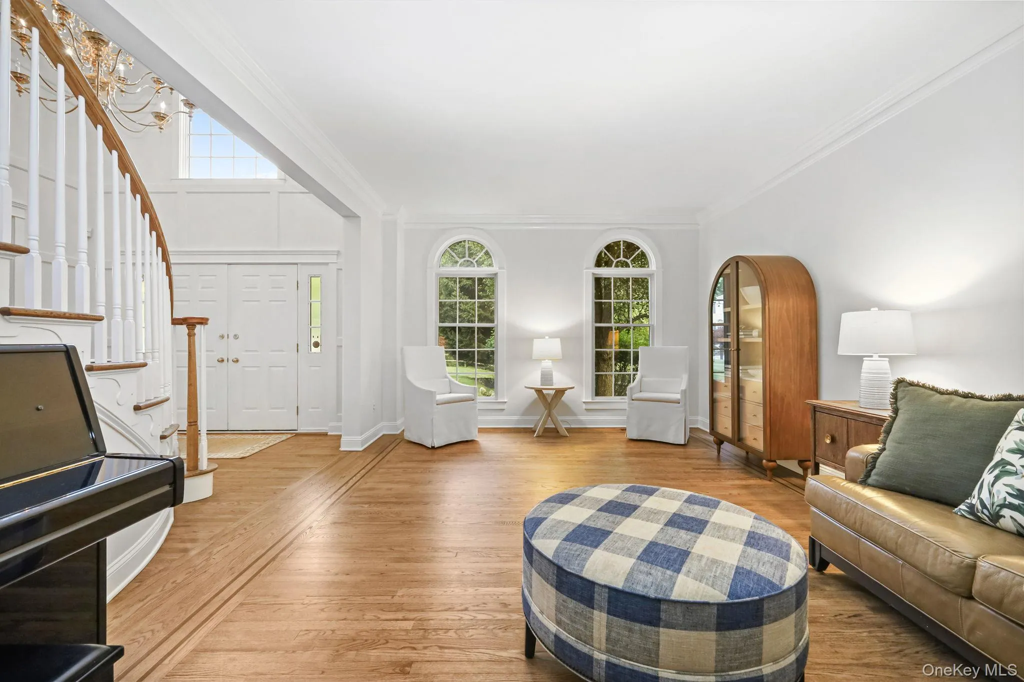 The formal living room is filled with sunlight. Notice the crown molding and inlaid walnut in the wood flooring. The formal living room is filled with sunlight. Notice the crown molding and inlaid walnut in the wood flooring.