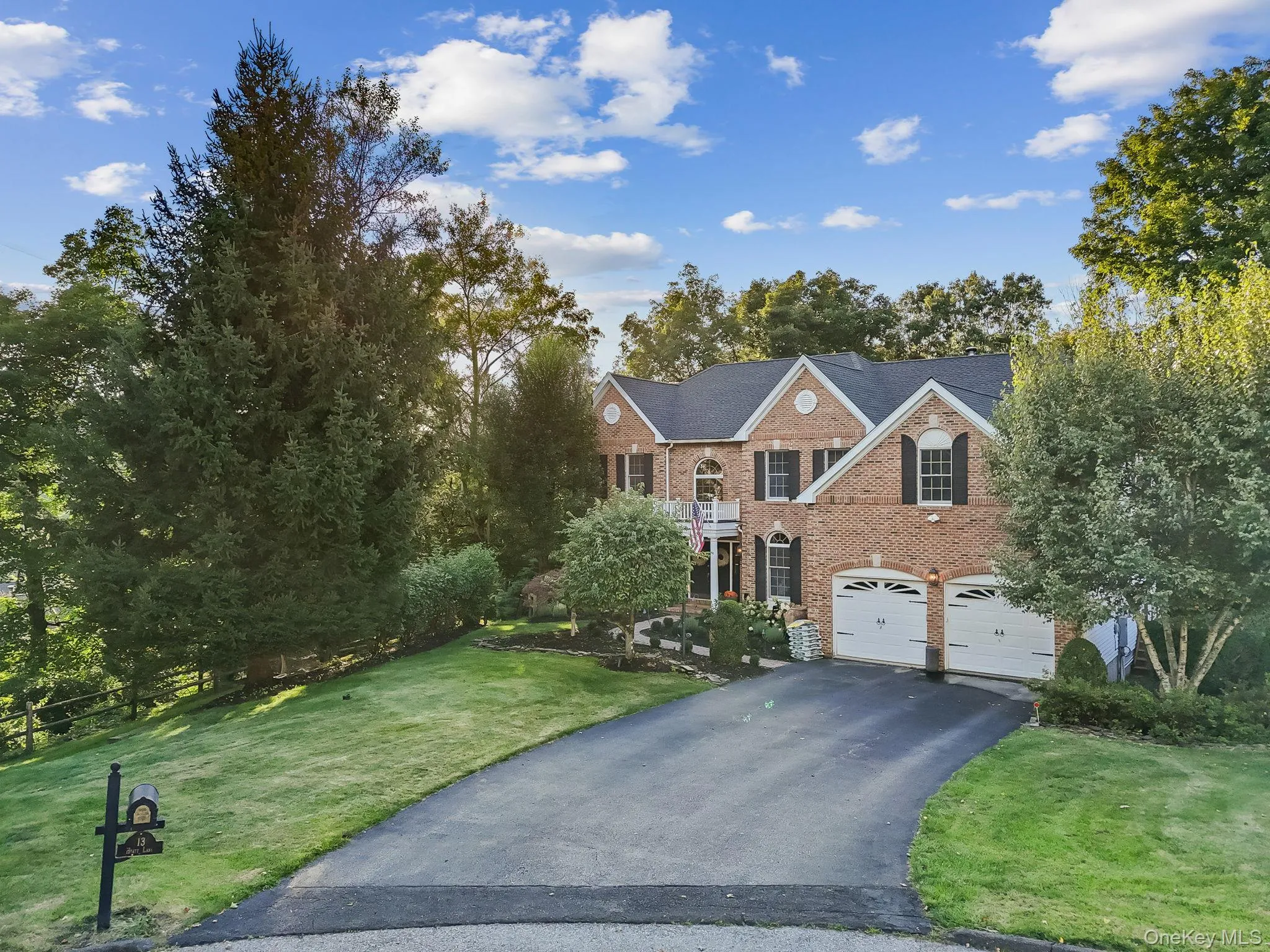 Mature trees, specimen plantings and an expansive lawn area frame the house. Mature trees, specimen plantings and an expansive lawn area frame the house.