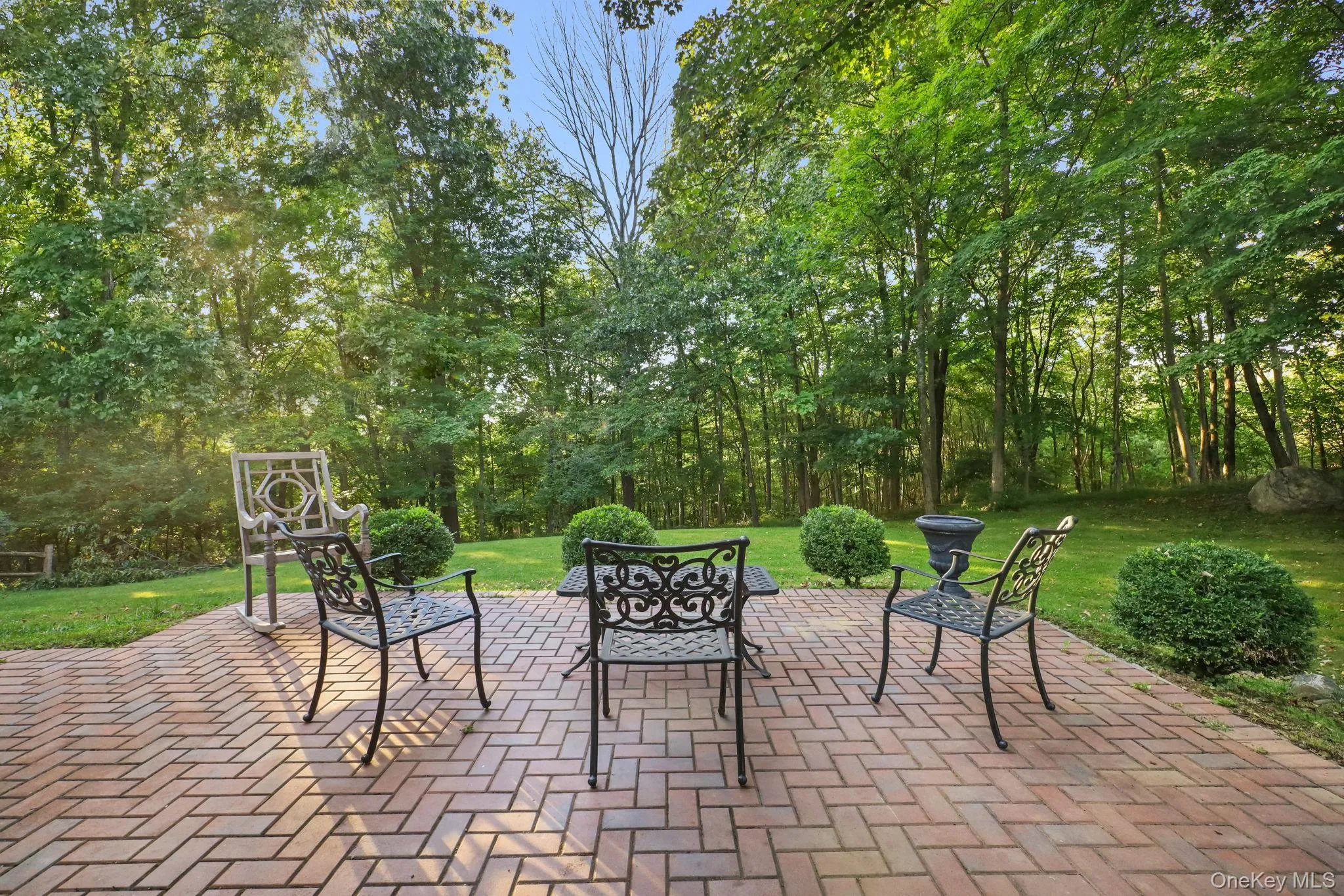 A beautiful stone patio is accessed from the lower level and overlooks the expansive lawn. A beautiful stone patio is accessed from the lower level and overlooks the expansive lawn.