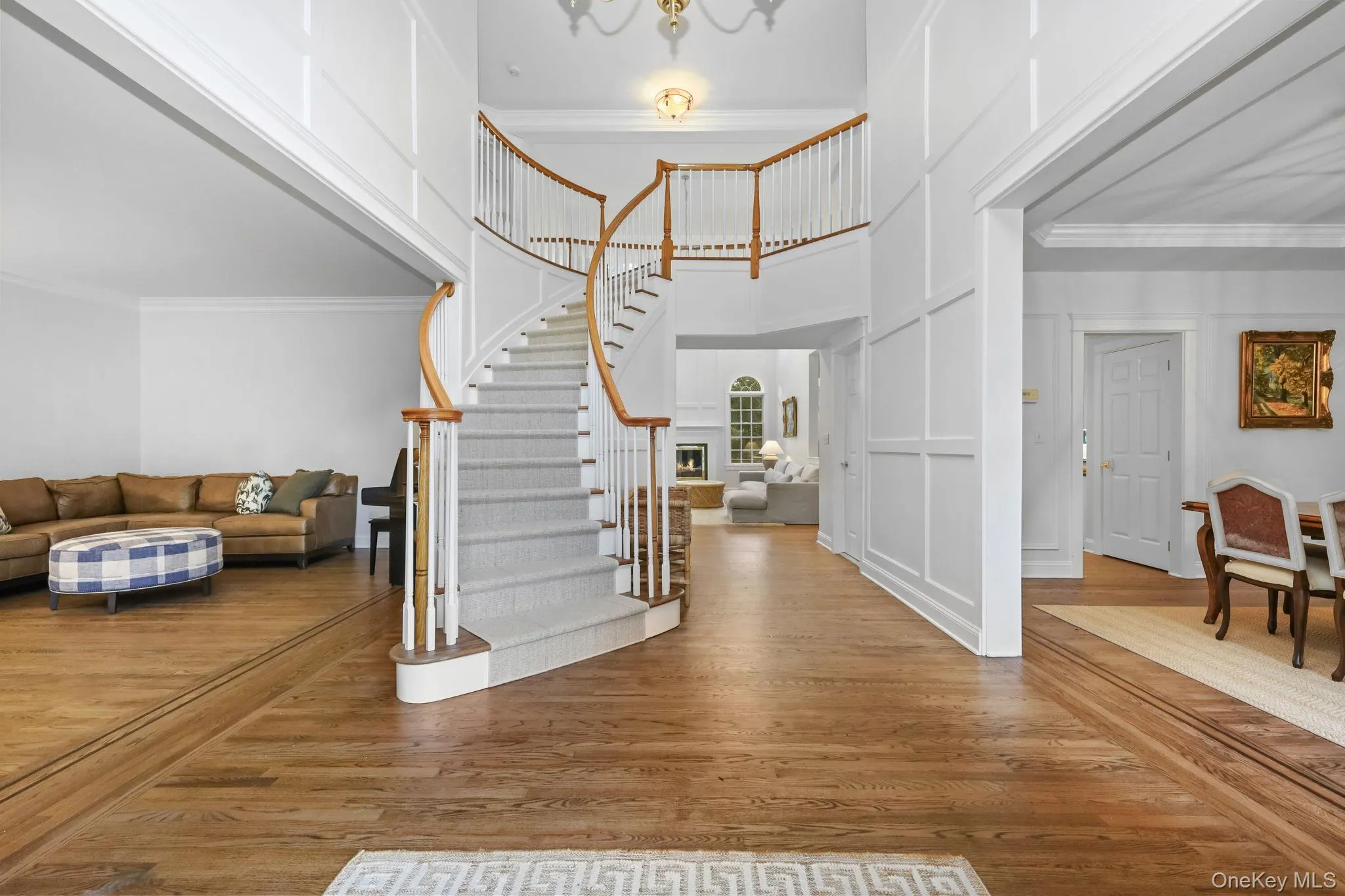 The open floor plan and grand curved staircase showcase the two-story entrance. The open floor plan and grand curved staircase showcase the two-story entrance.