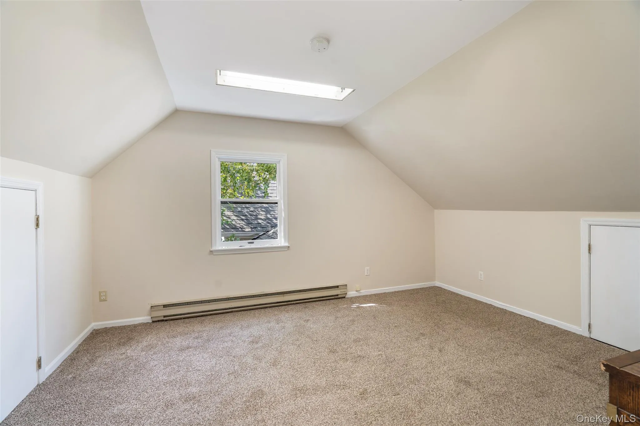 Bedroom with 2 attic storage accesses Bedroom with 2 attic storage accesses