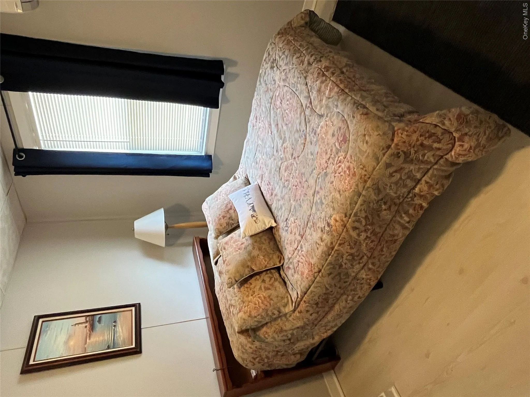 Bedroom featuring wood finished floors and a wall unit AC Bedroom featuring wood finished floors and a wall unit AC