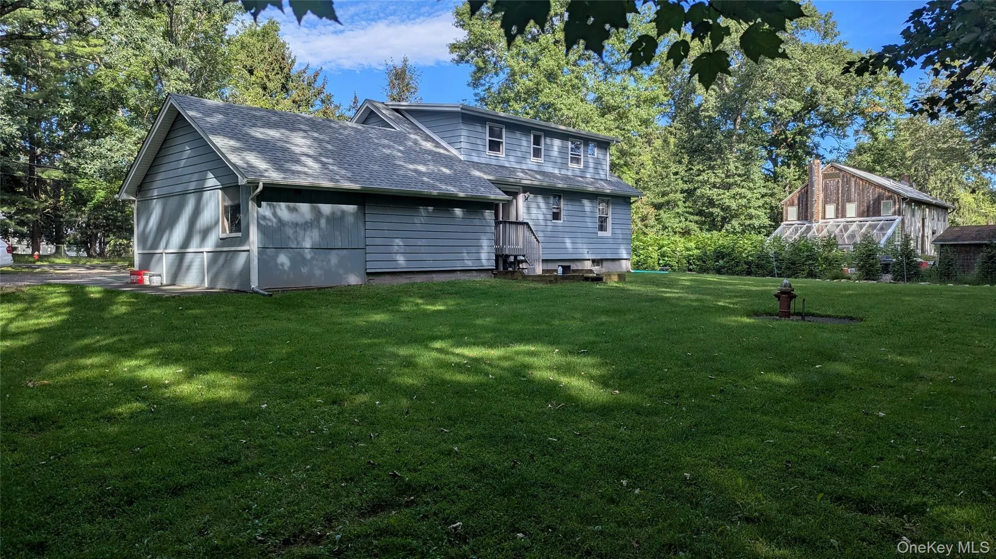 Expansive green lawn with mature trees Expansive green lawn with mature trees