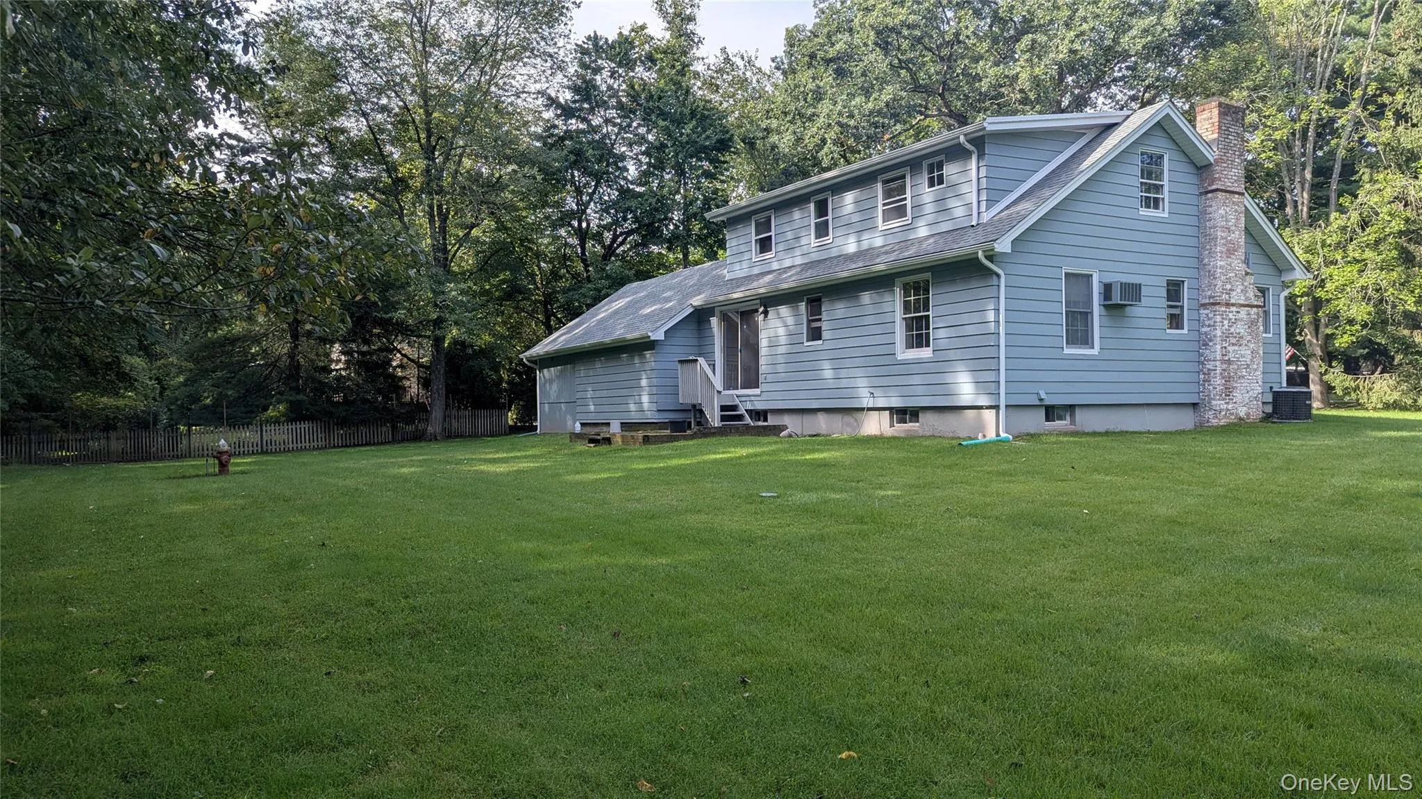 Expansive green lawn with mature perimeter trees Expansive green lawn with mature perimeter trees