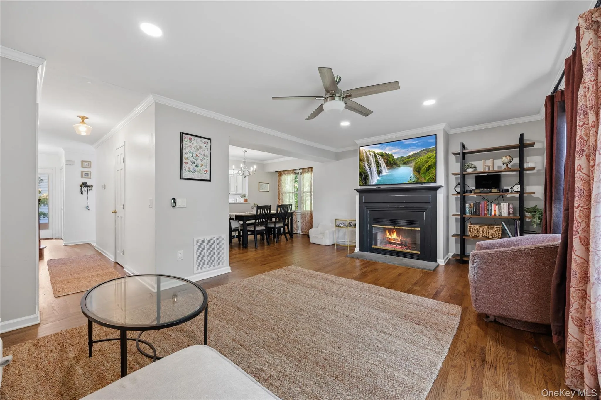 The wood burning fireplace enhances the comfortability and coziness of this space. In addition to removing the popcorn ceilings, new recessed lighting, ceiling fan and crown molding have been added. The wood burning fireplace enhances the comfortability and coziness of this space. In addition to removing the popcorn ceilings, new recessed lighting, ceiling fan and crown molding have been added.