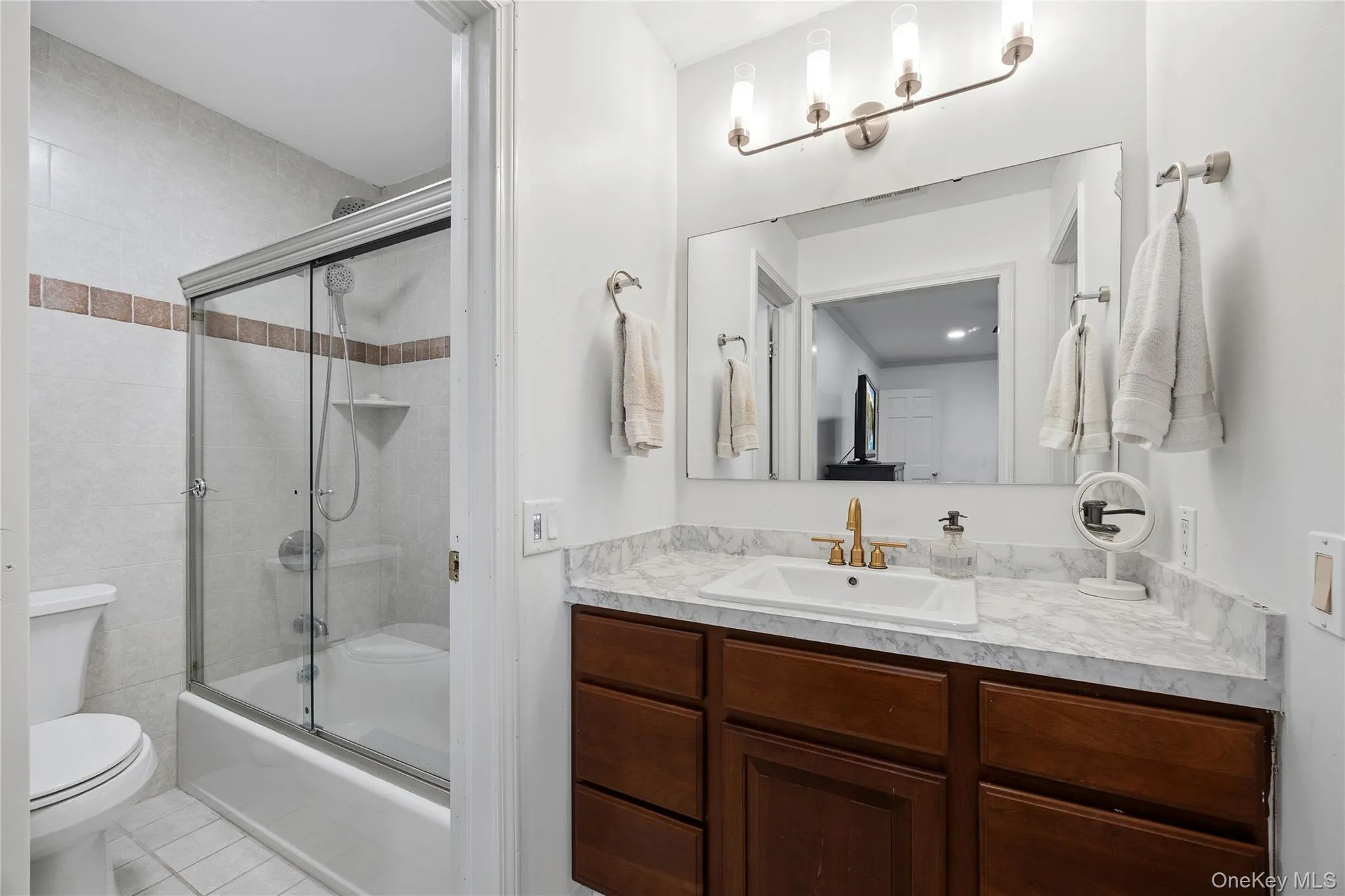 The Primary Bathroom features a gleaming full-tile tub/shower, new vanity, sink quiet fan and faucet. The Primary Bathroom features a gleaming full-tile tub/shower, new vanity, sink quiet fan and faucet.