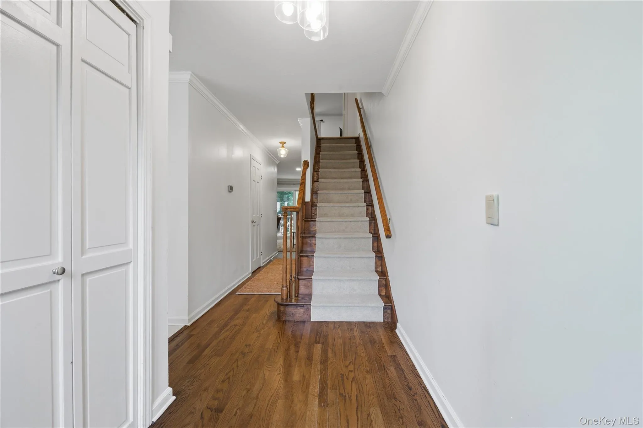 Hardwood stairs lead up to the upper (Bedroom) level. There is a large coat closet to the left. Hardwood stairs lead up to the upper (Bedroom) level. There is a large coat closet to the left.