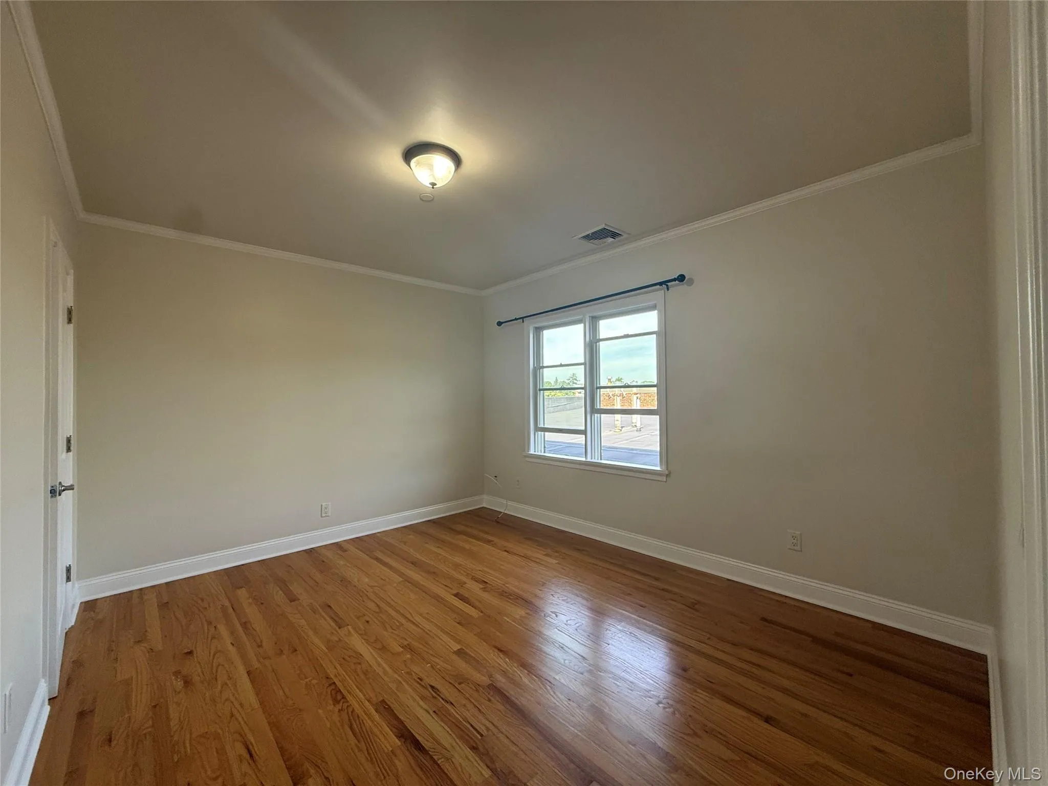 Bedroom with wood floors, walk in closet and en-suite bathroom Bedroom with wood floors, walk in closet and en-suite bathroom
