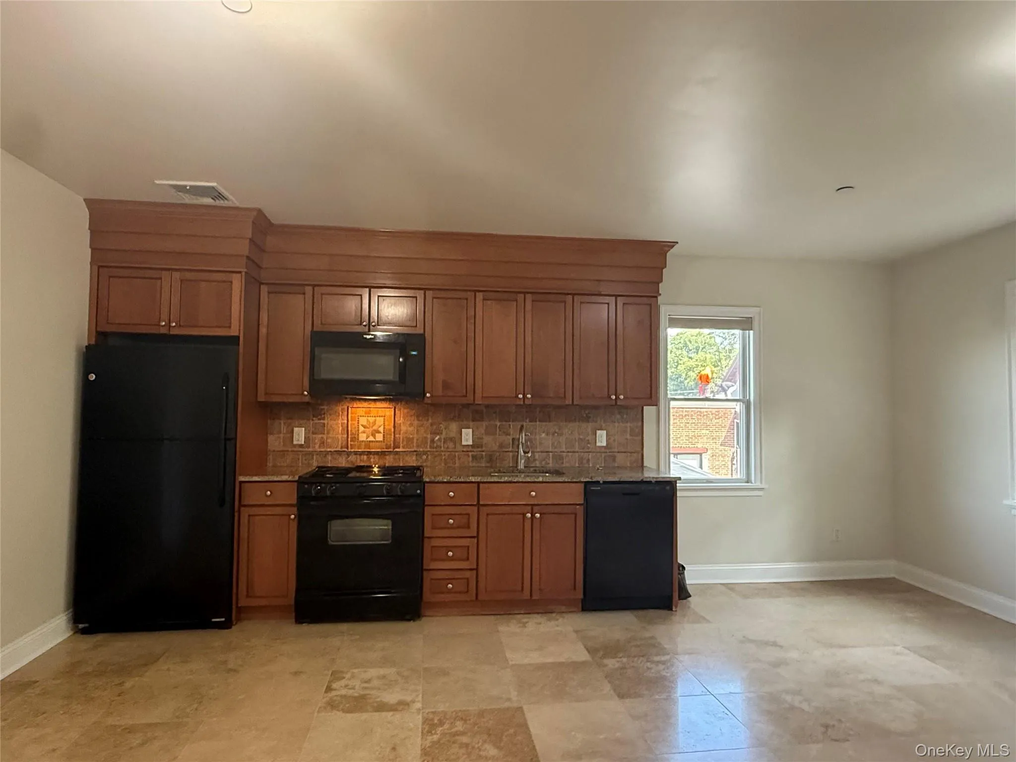 Kitchen has wood cabinets, stone counter and full zixe appliances Kitchen has wood cabinets, stone counter and full zixe appliances