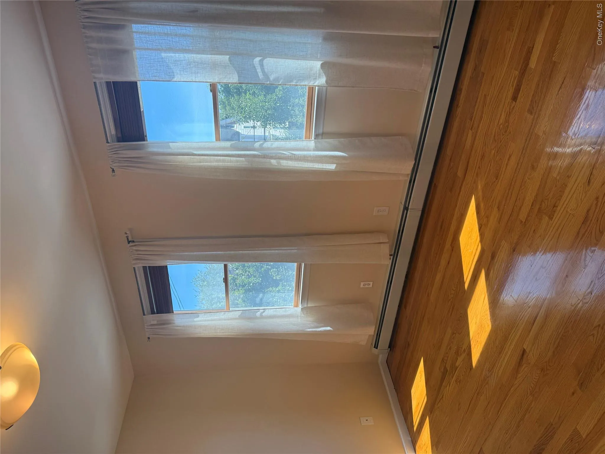 Primary Bedroom with Gleaming Hardwood Floors and Double Closet Primary Bedroom with Gleaming Hardwood Floors and Double Closet