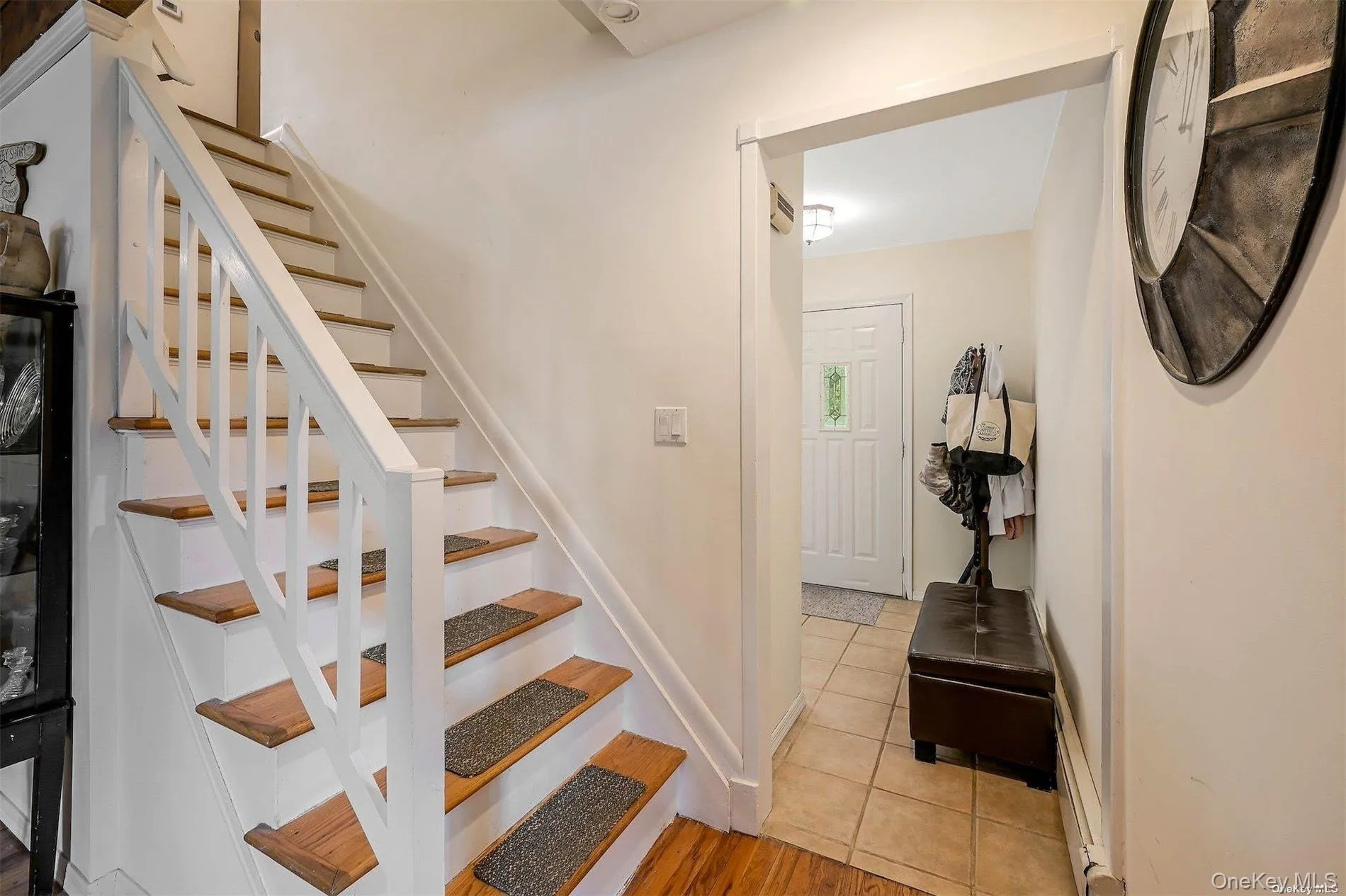 Wood-finish staircase with white risers and railings Wood-finish staircase with white risers and railings