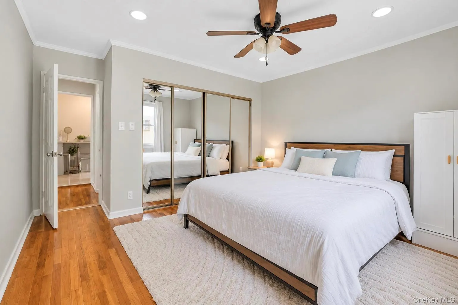 Hardwood flooring, recessed lighting, ceiling fan, mirrored closet doors, and crown molding Hardwood flooring, recessed lighting, ceiling fan, mirrored closet doors, and crown molding