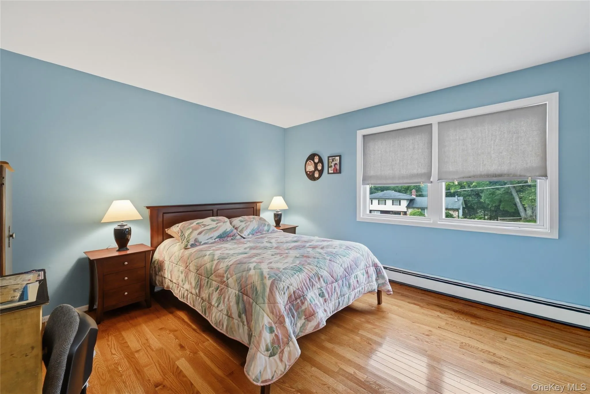 Hardwood flooring, painted walls, and a large window Hardwood flooring, painted walls, and a large window